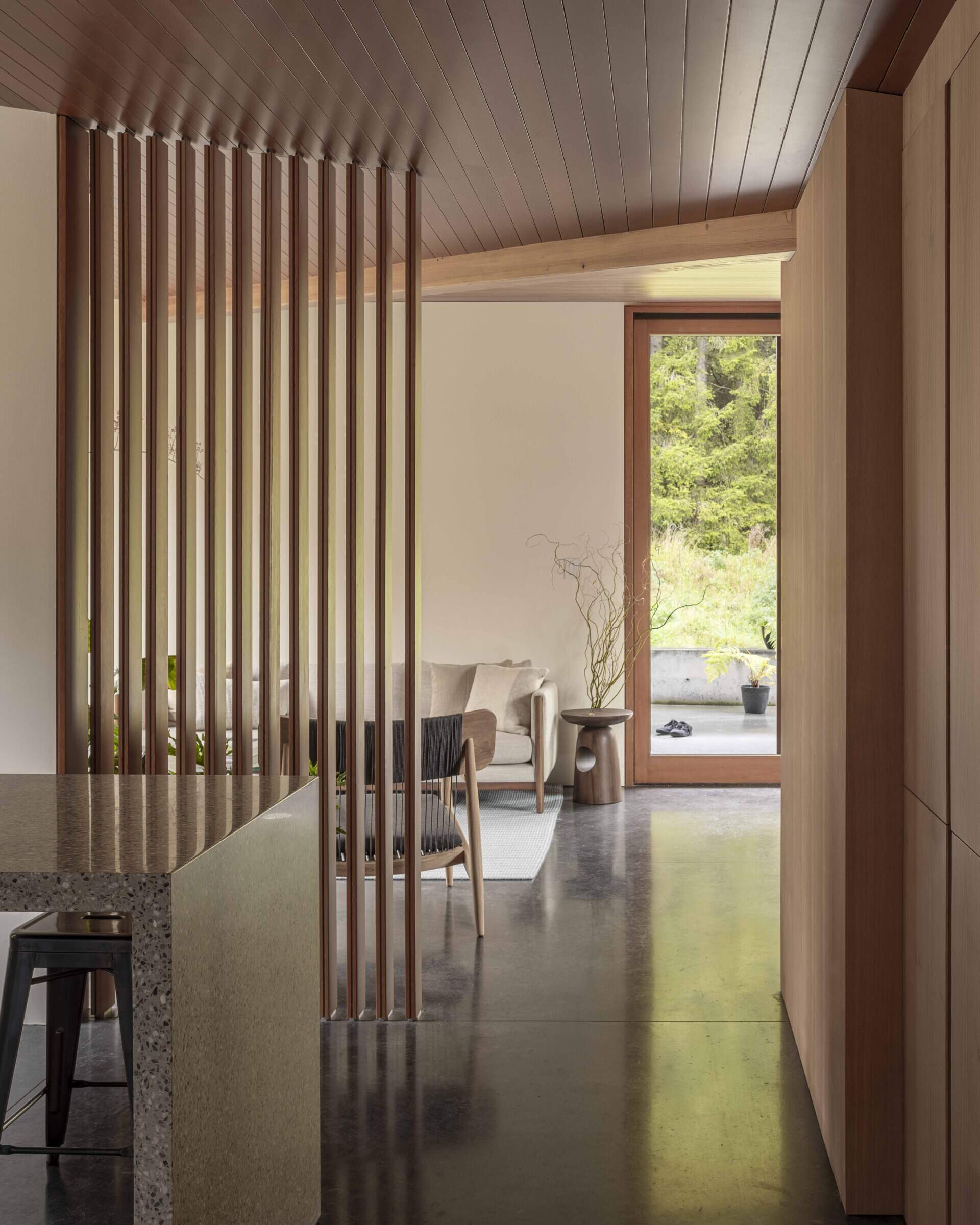 Inside, natural materials and handmade details tell a personal story. Locally sourced fir and cedar, terrazzo, and radiant concrete floors create a warm, practical backdrop for art, craft, and quiet reflection.