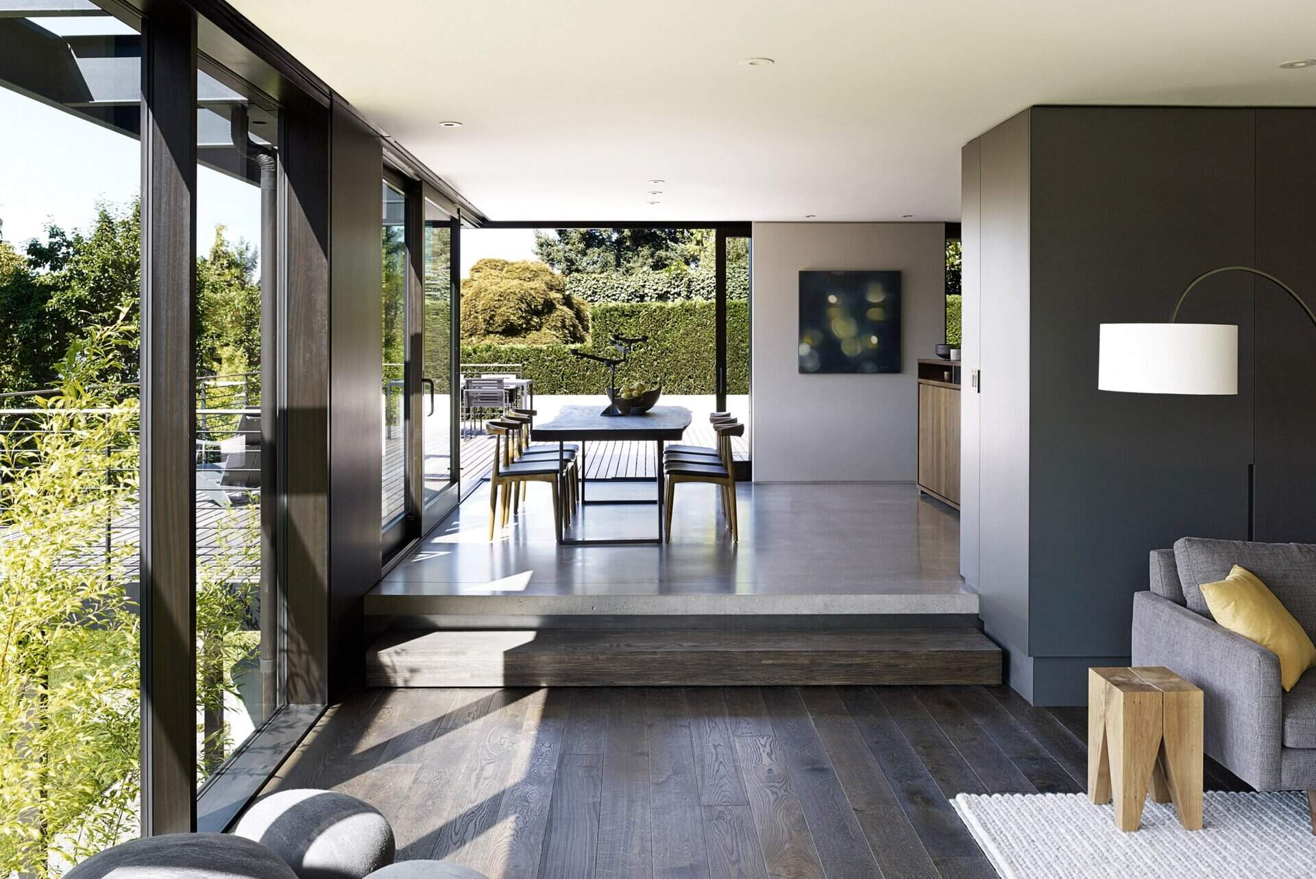 Dark wood and gray cabinetry bring warmth and sophistication to a kitchen now opened up to the dining area and lake-view deck.