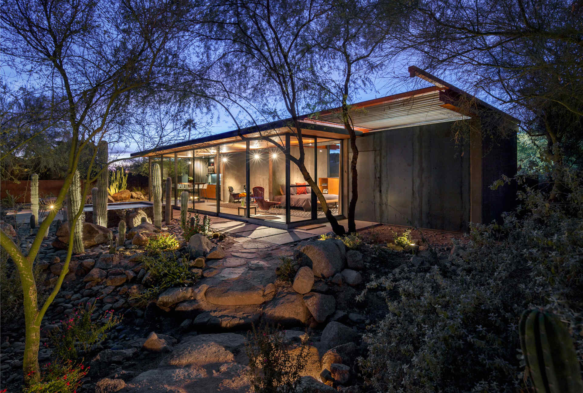 Once a working barn in Phoenix, this guest house by The Construction Zone features full-height glass, concrete, and Douglas fir details that highlight desert modernism.