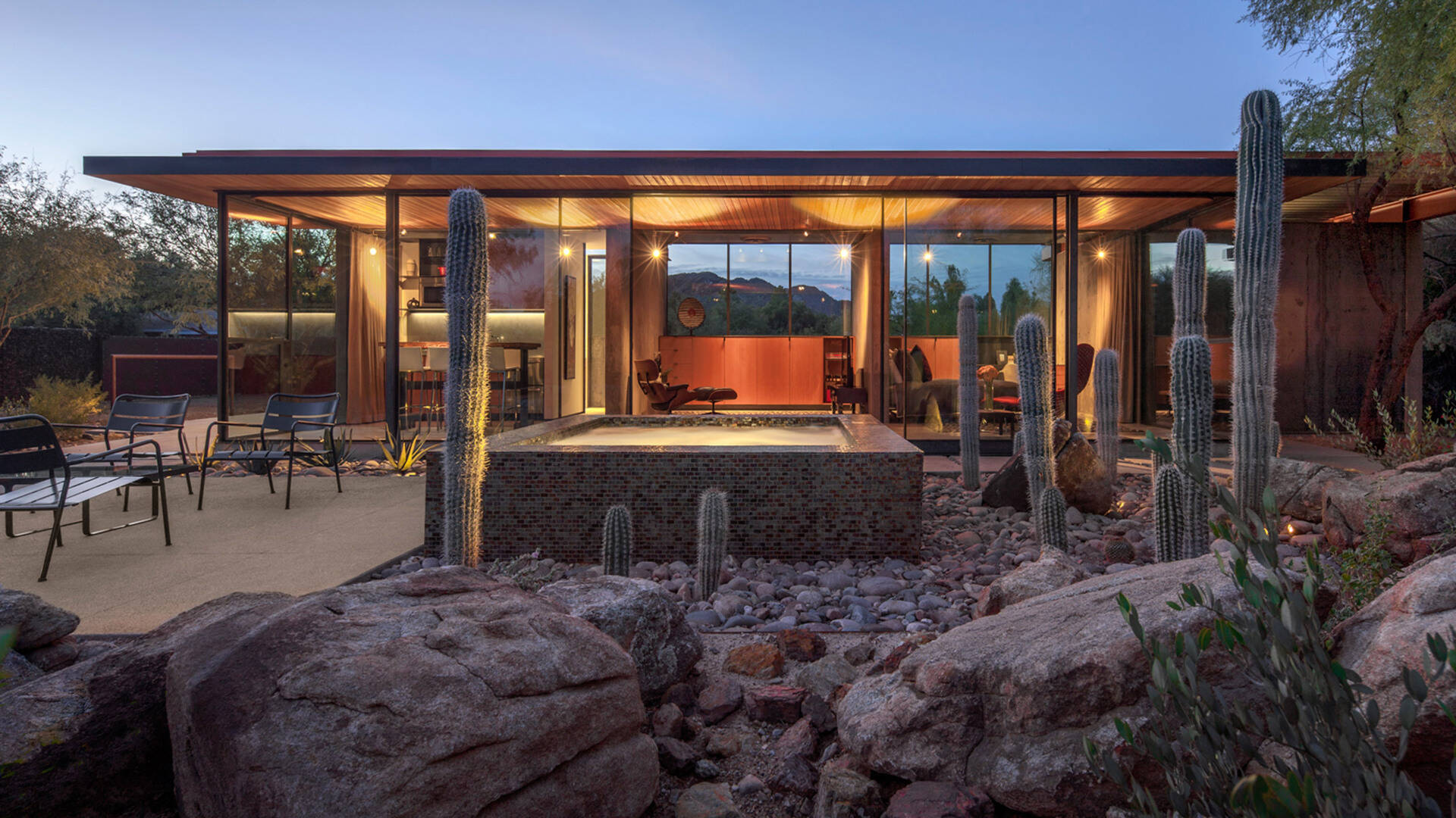 Once a working barn in Phoenix, this guest house by The Construction Zone features full-height glass, concrete, and Douglas fir details that highlight desert modernism.