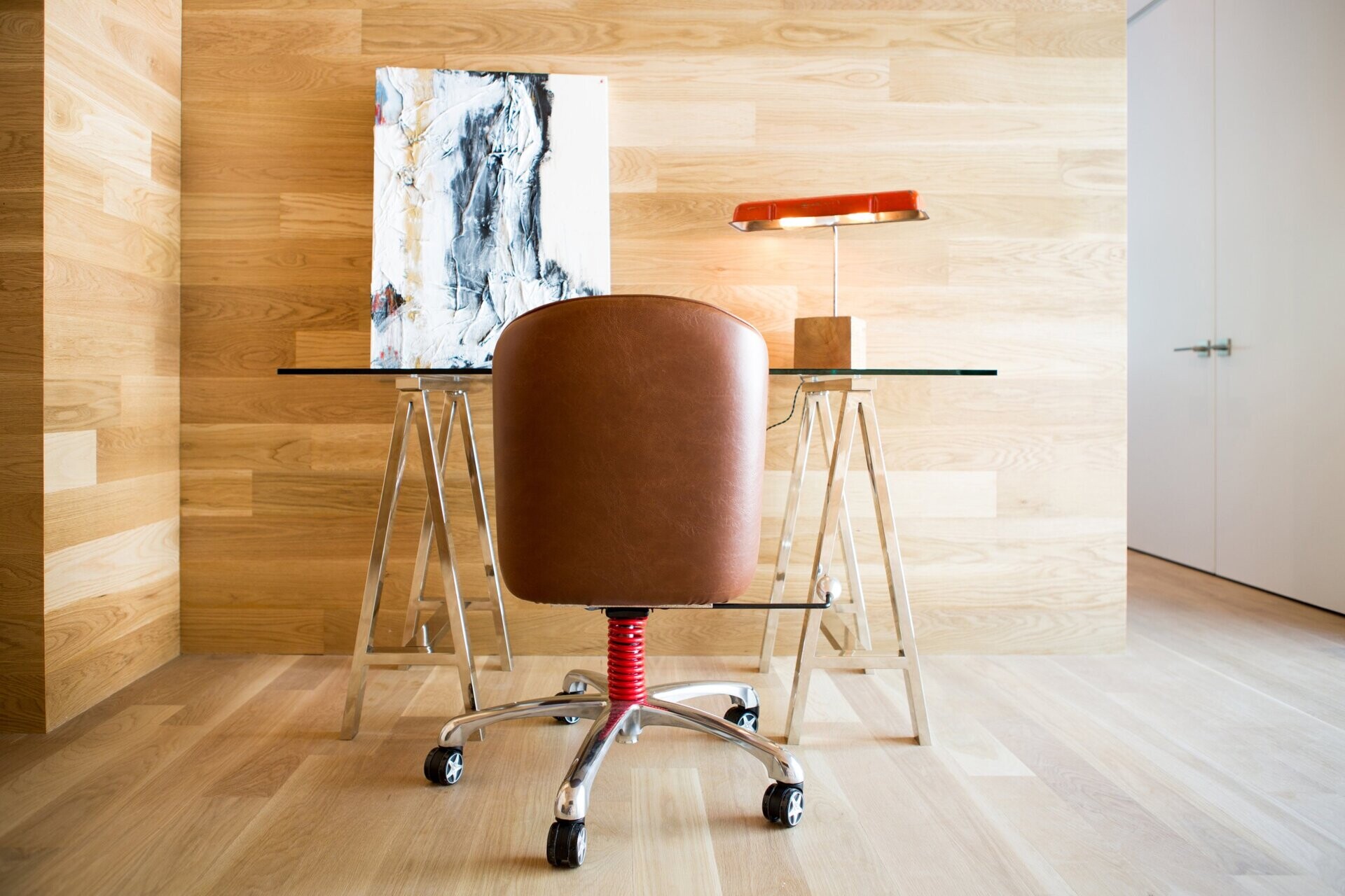 A small hallway leads to a home office nook, surrounded by natural wood for warmth and focus.