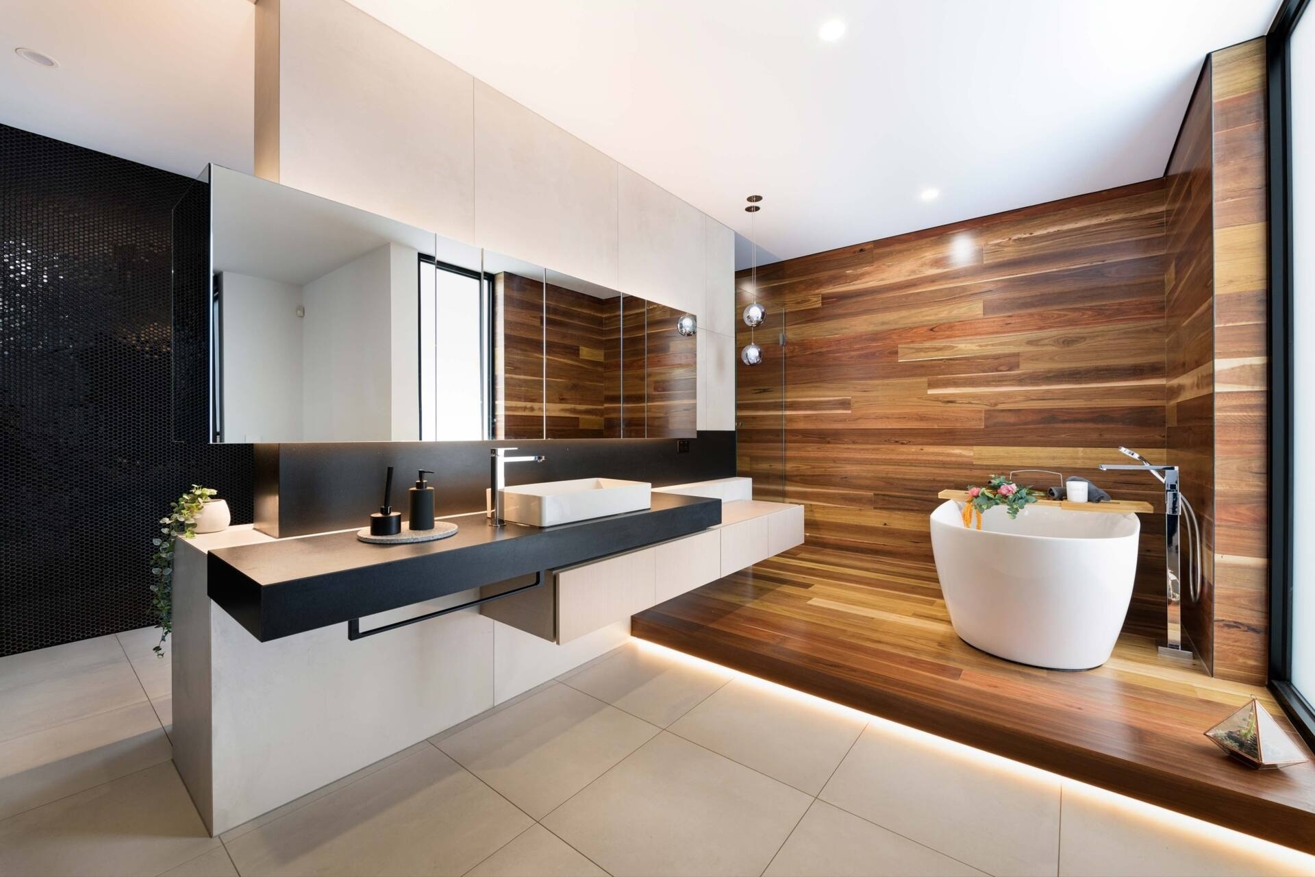 In this modern bathroom, the concrete’s texture takes on a quieter character. Here, the polished finishes meet soft timber tones, grounding the design in material honesty. Light and shadow animate the surfaces, keeping the spaces alive even in stillness.