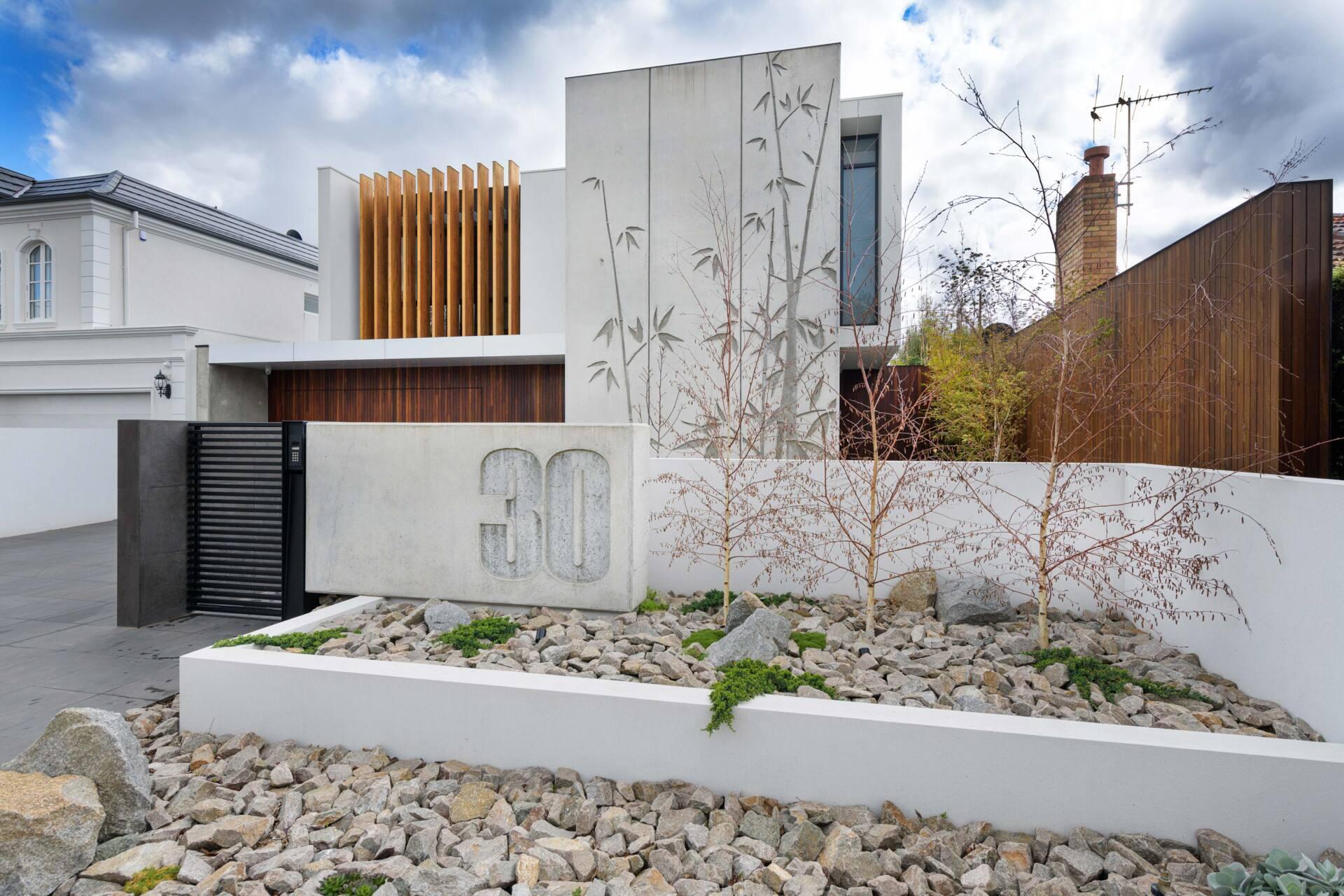 Tilt-up concrete panels with bamboo reliefs give this home a sculptural edge. The combination of raw concrete and natural texture strikes a balance between industrial and organic design.