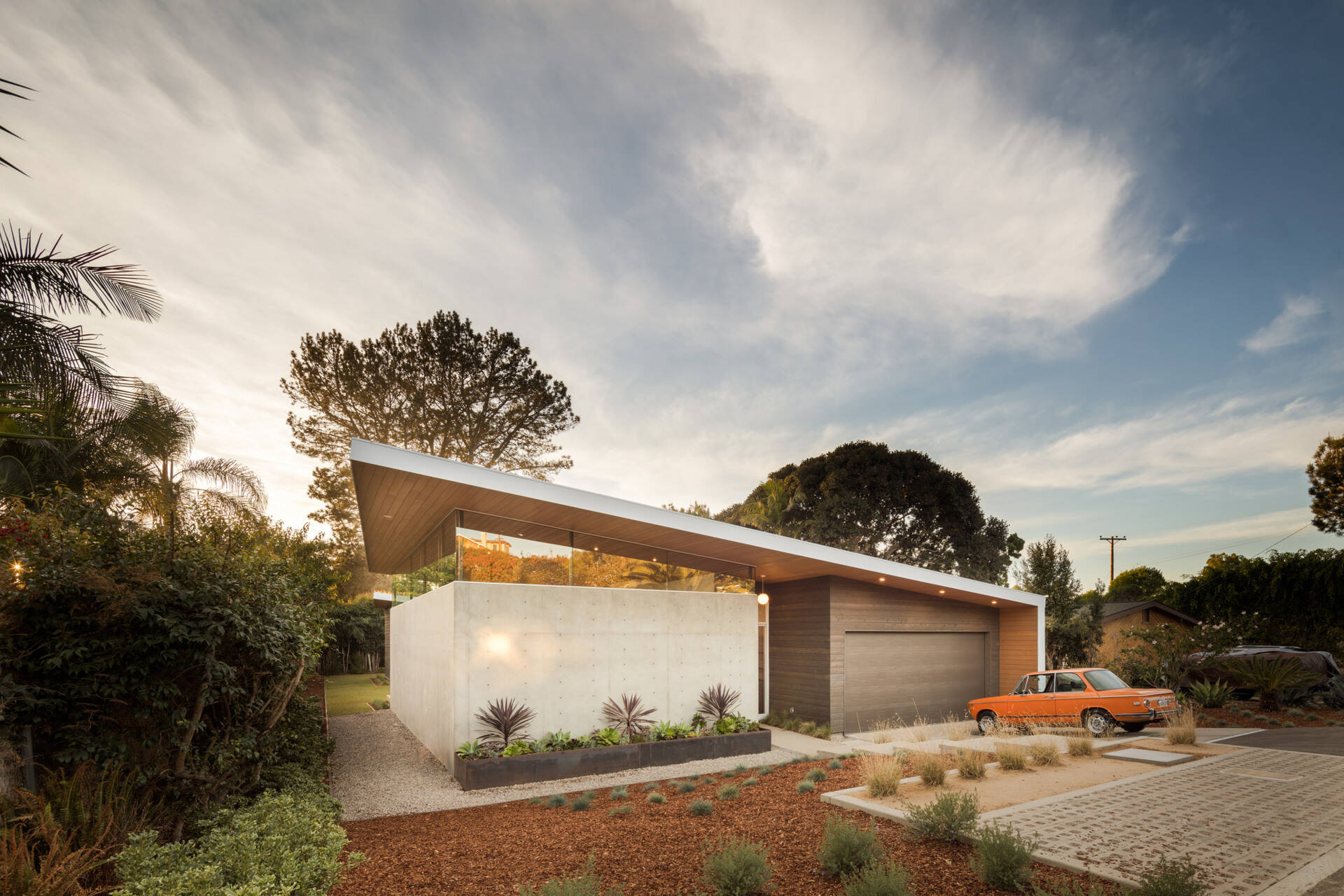 A bright yellow front door and angular roofline make this California home stand out from the street.