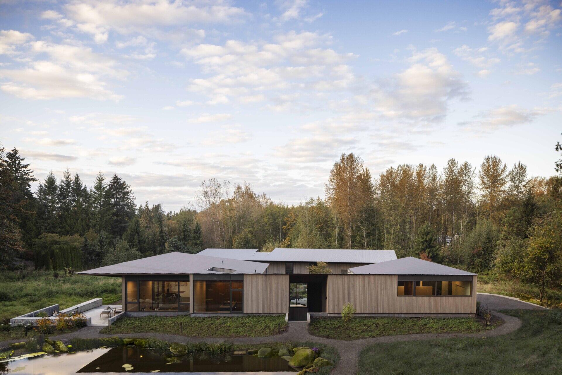 Designed by Wittman Estes, this single-level home nestles into a sloped wetland site with gentle terracing, wide thresholds, and seamless indoor-outdoor flow. Its form celebrates climate and craft, uniting accessibility with artistry for a couple who live and create side by side.