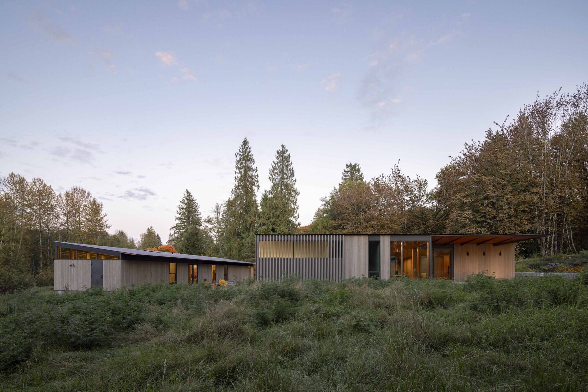 Designed by Wittman Estes, this single-level home nestles into a sloped wetland site with gentle terracing, wide thresholds, and seamless indoor-outdoor flow. Its form celebrates climate and craft, uniting accessibility with artistry for a couple who live and create side by side.