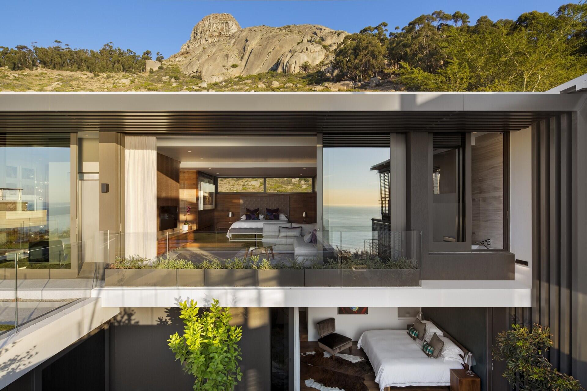 Beneath the master suite, a lower-floor bedroom opens to its own private garden. Its design continues the home’s commitment to seamless indoor-outdoor living while providing a quiet space away from the main entertaining areas.