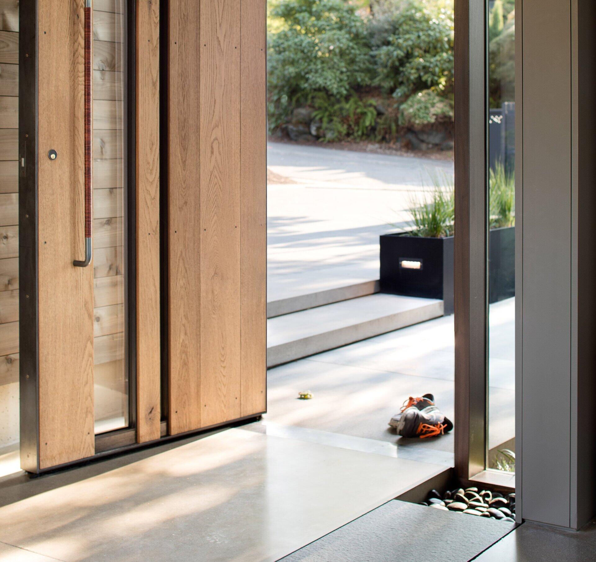 This renovated midcentury home blends 1960s charm with modern updates, featuring floor-to-ceiling glass, radiant heating, and a tranquil central courtyard.