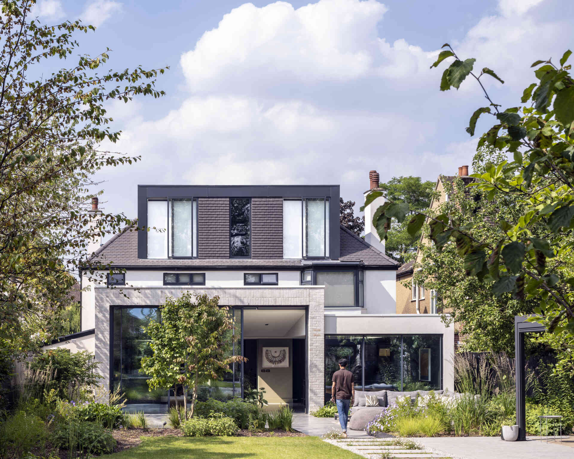 The new extension floods the home with daylight, creating a seamless link between the house and garden.