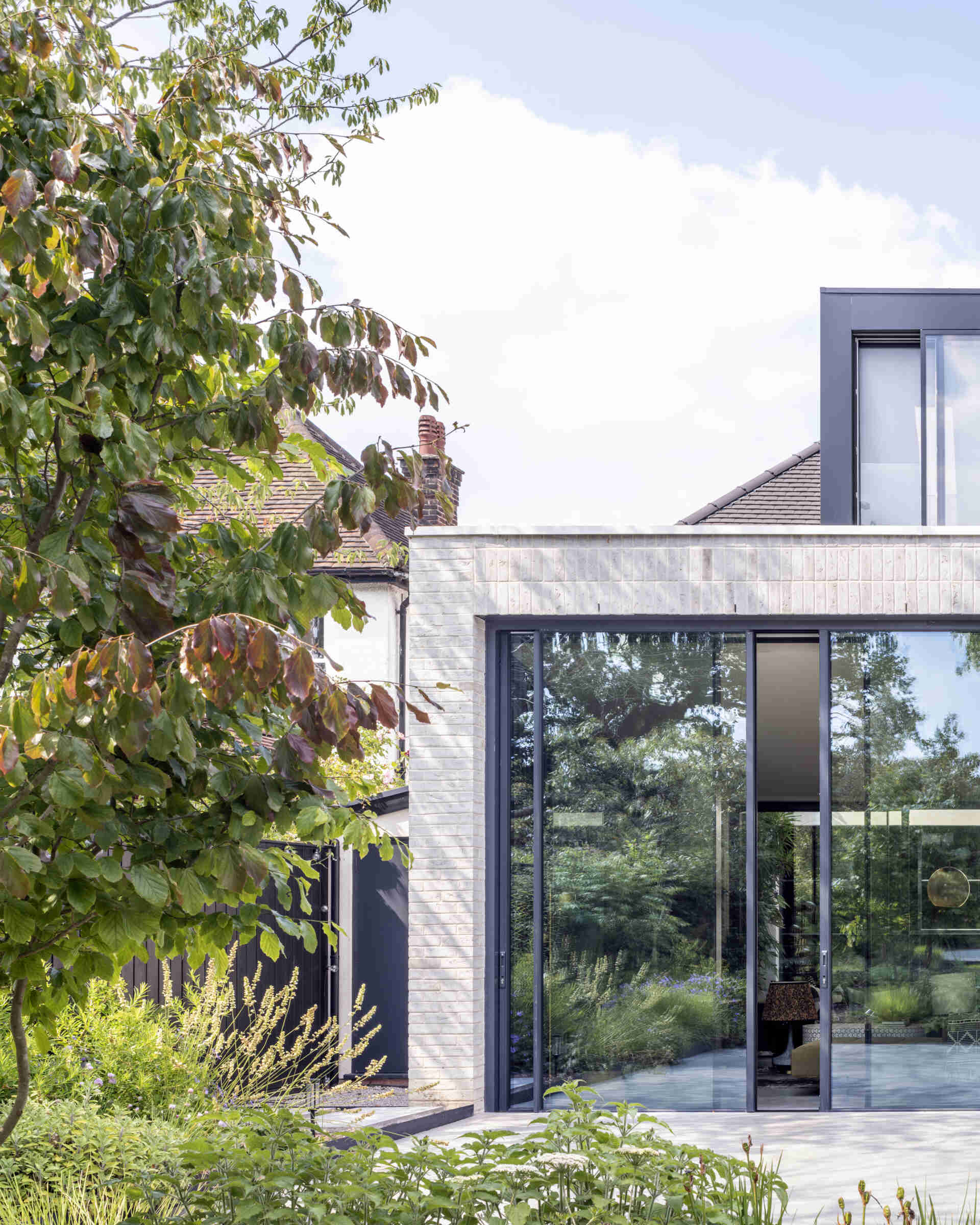 The new extension floods the home with daylight, creating a seamless link between the house and garden.