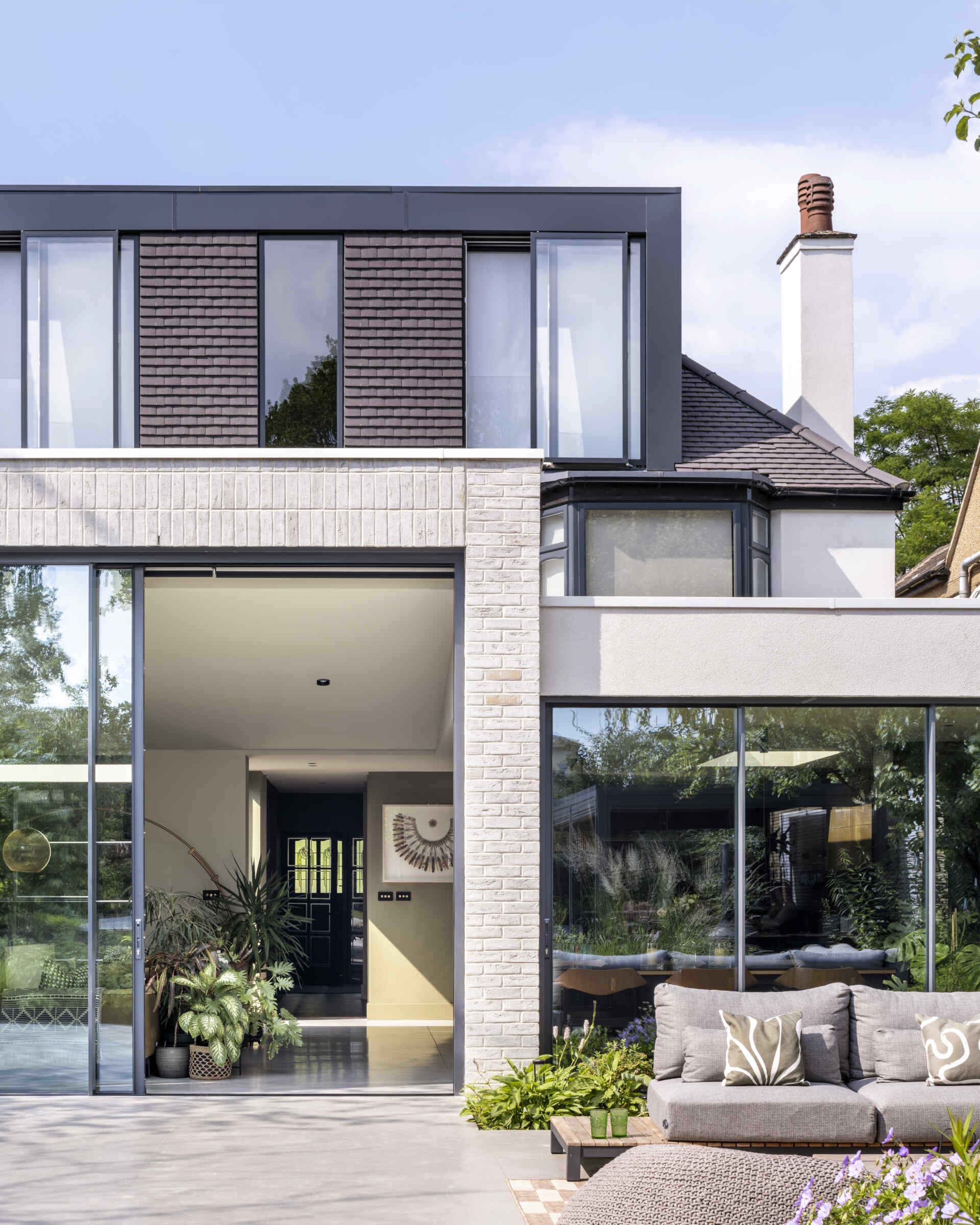The new extension floods the home with daylight, creating a seamless link between the house and garden.
