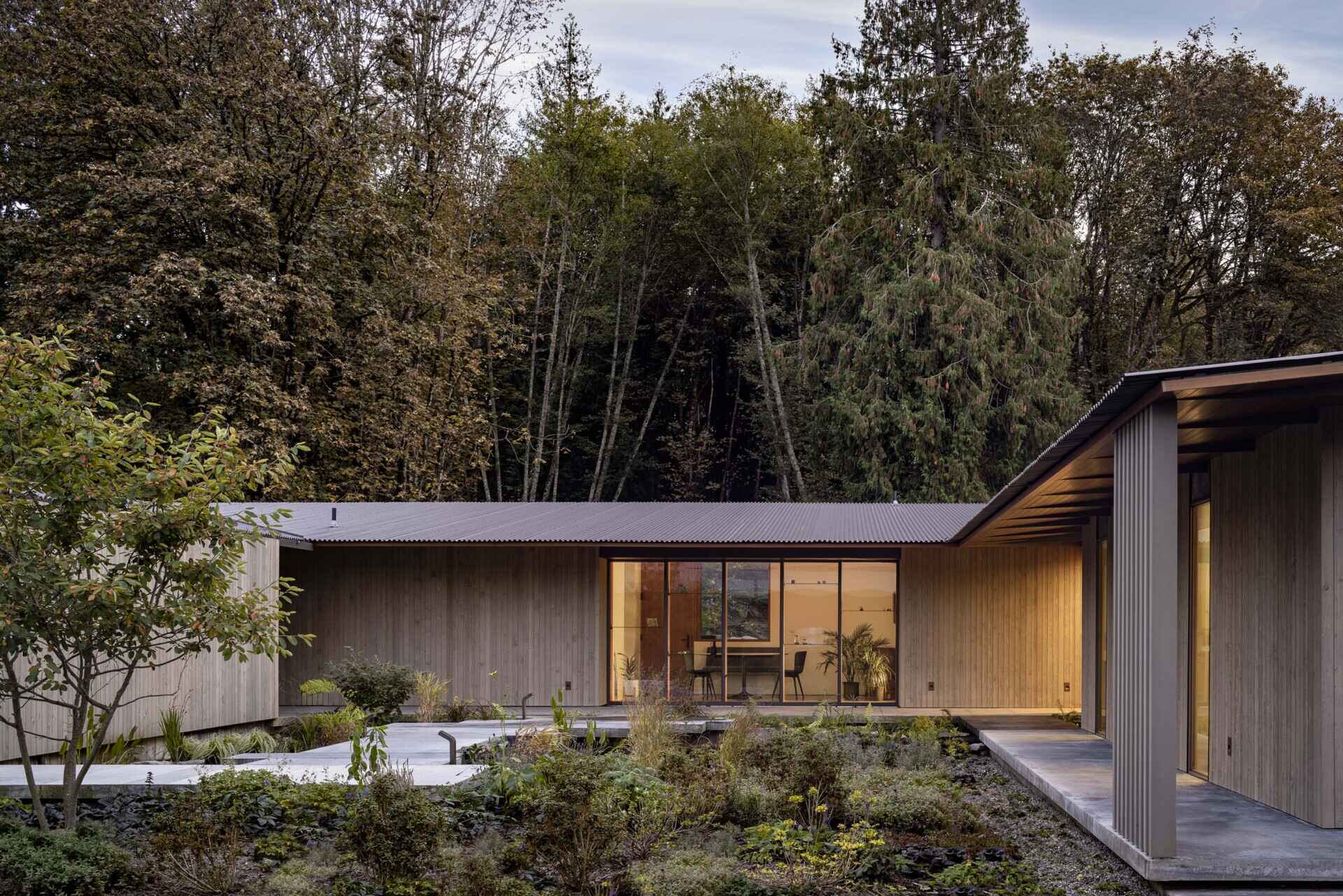 Reflecting pools, rain-fed gardens, and native plantings weave this home into its natural setting. Inspired by an ancient Roman impluvium, water cascades from broad eaves into shallow pools, turning rainfall into a living, ever-changing landscape.