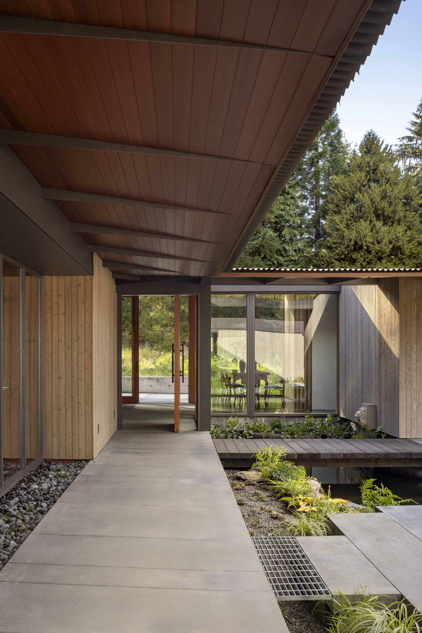 Reflecting pools, rain-fed gardens, and native plantings weave this home into its natural setting. Inspired by an ancient Roman impluvium, water cascades from broad eaves into shallow pools, turning rainfall into a living, ever-changing landscape.
