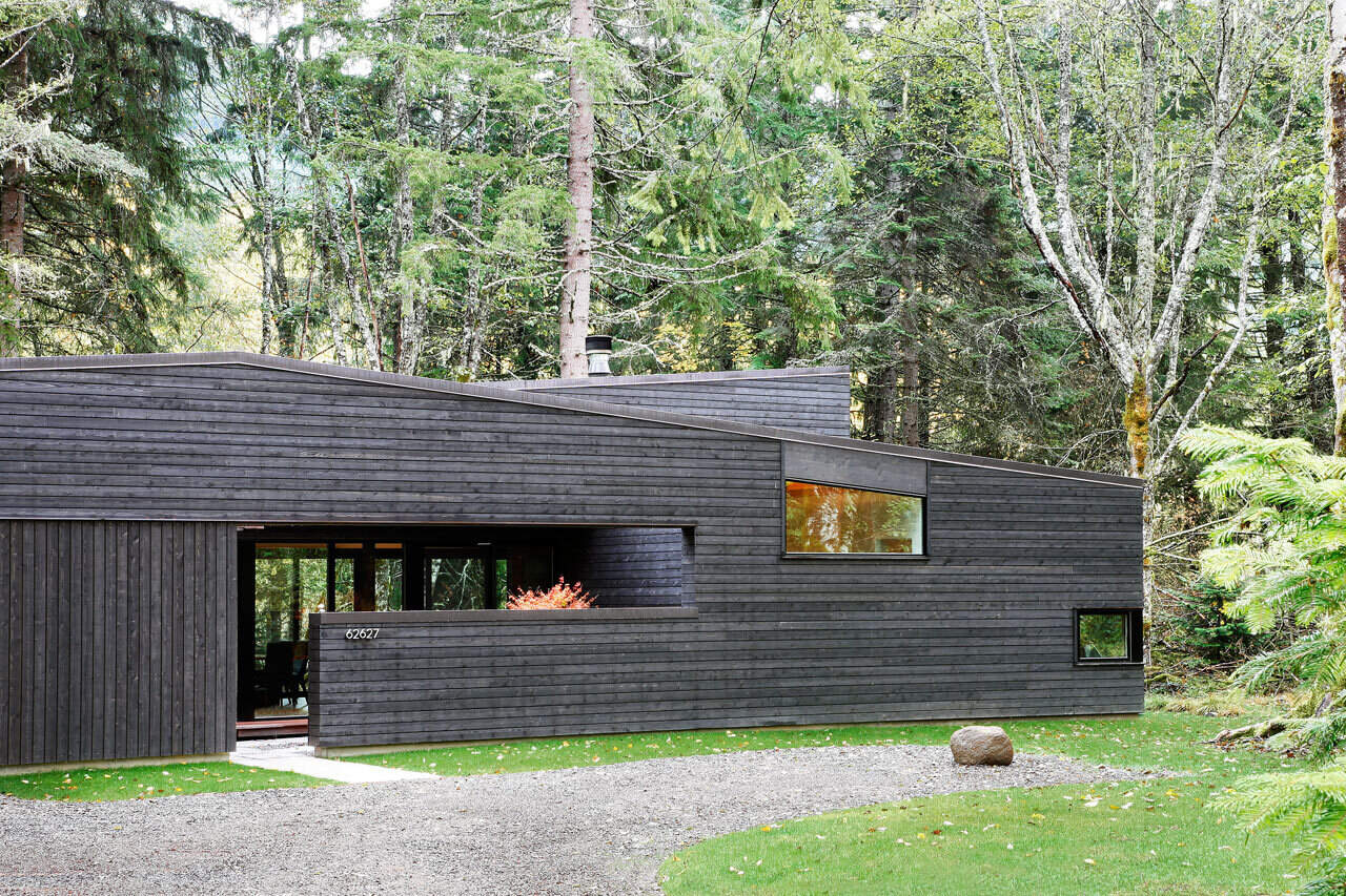 A private courtyard acts as a serene transition from forest to home, beautifully designed to balance light and keep wandering elk at bay.