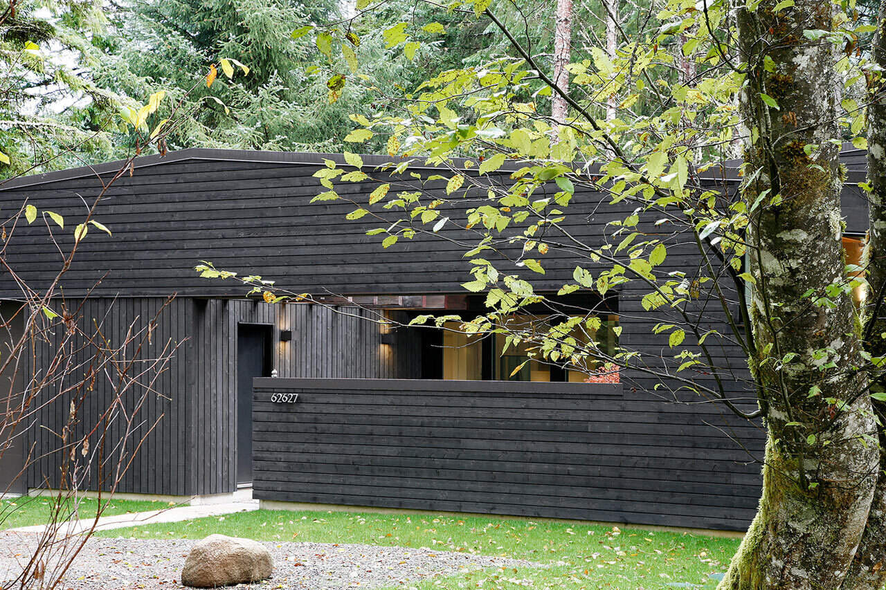 A private courtyard acts as a serene transition from forest to home, beautifully designed to balance light and keep wandering elk at bay.