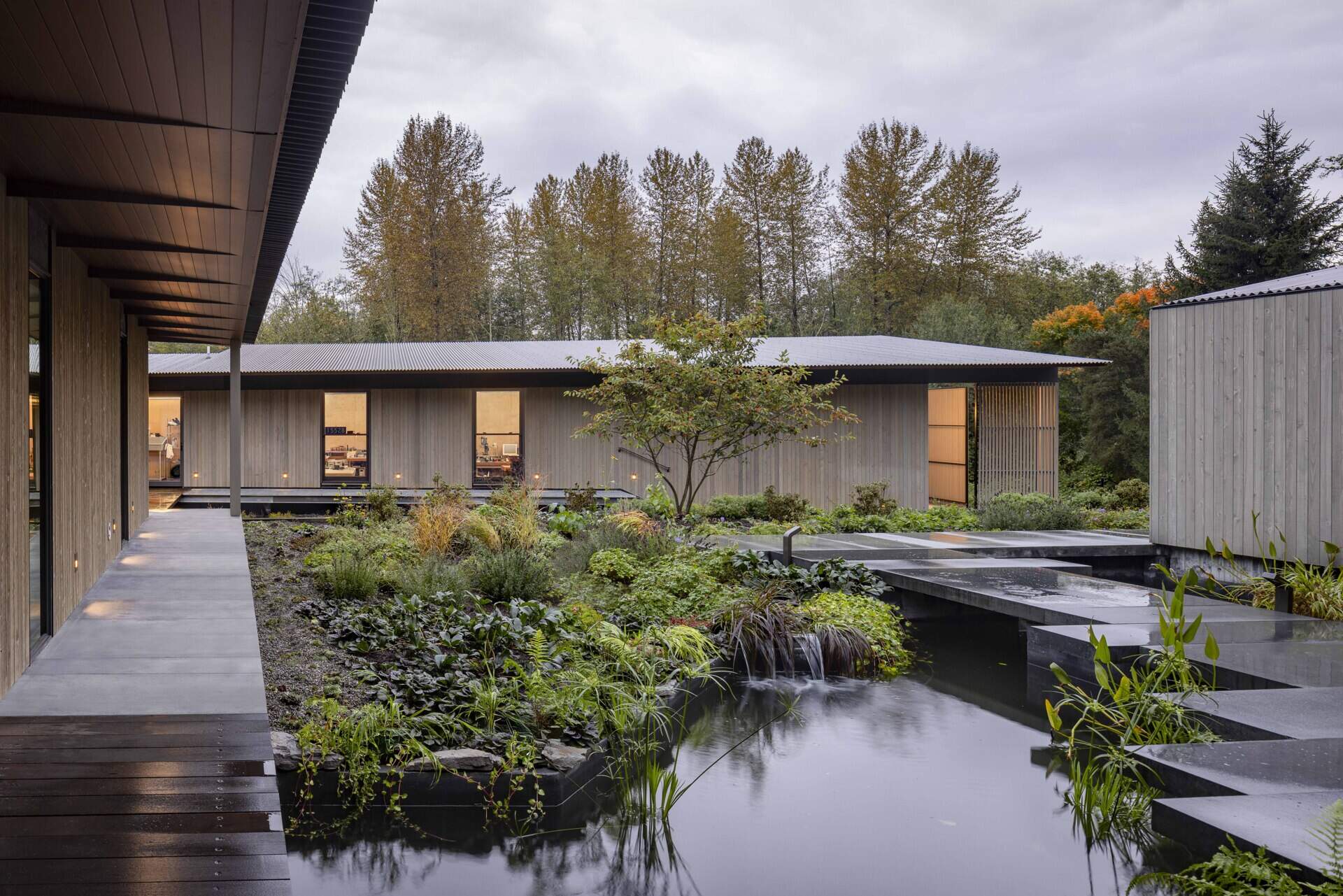 Reflecting pools, rain-fed gardens, and native plantings weave this home into its natural setting. Inspired by an ancient Roman impluvium, water cascades from broad eaves into shallow pools, turning rainfall into a living, ever-changing landscape.