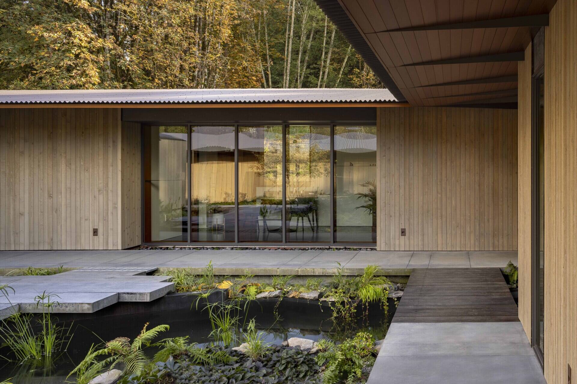 Reflecting pools, rain-fed gardens, and native plantings weave this home into its natural setting. Inspired by an ancient Roman impluvium, water cascades from broad eaves into shallow pools, turning rainfall into a living, ever-changing landscape.