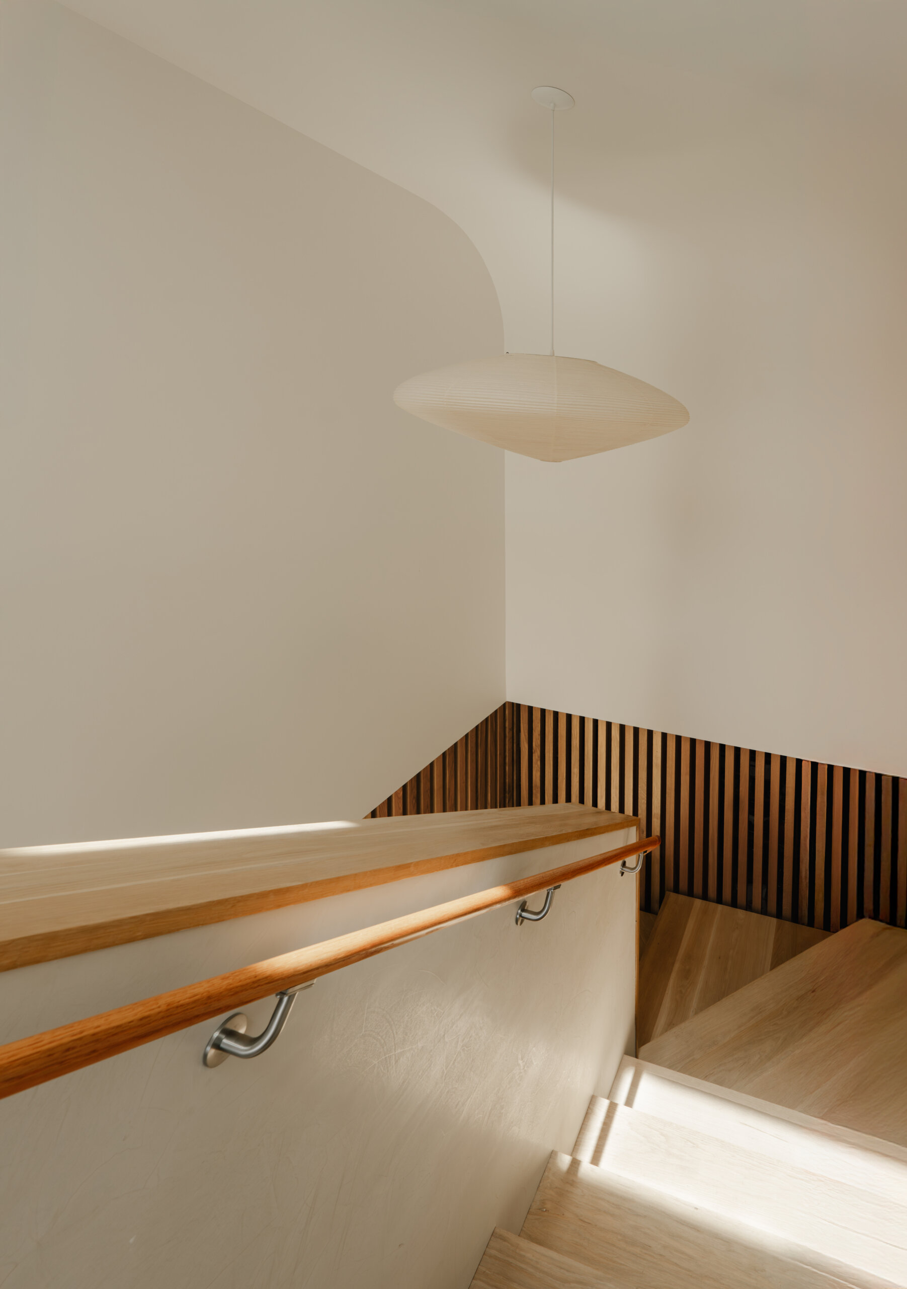 At the heart of the home, a central skylit stairwell channels sunlight and functions as a passive ventilation chimney.