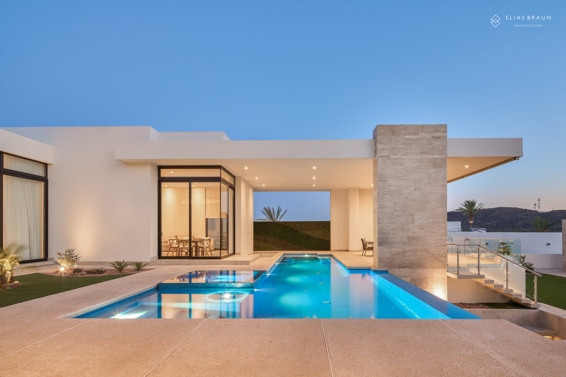 A stepped desert home where water and air define the experience. The infinity pool meets the horizon, while a central courtyard gathers breezes and connects the main house with the guest wing. Travertine terraces and soft light make every transition, from swim to social, effortless.
