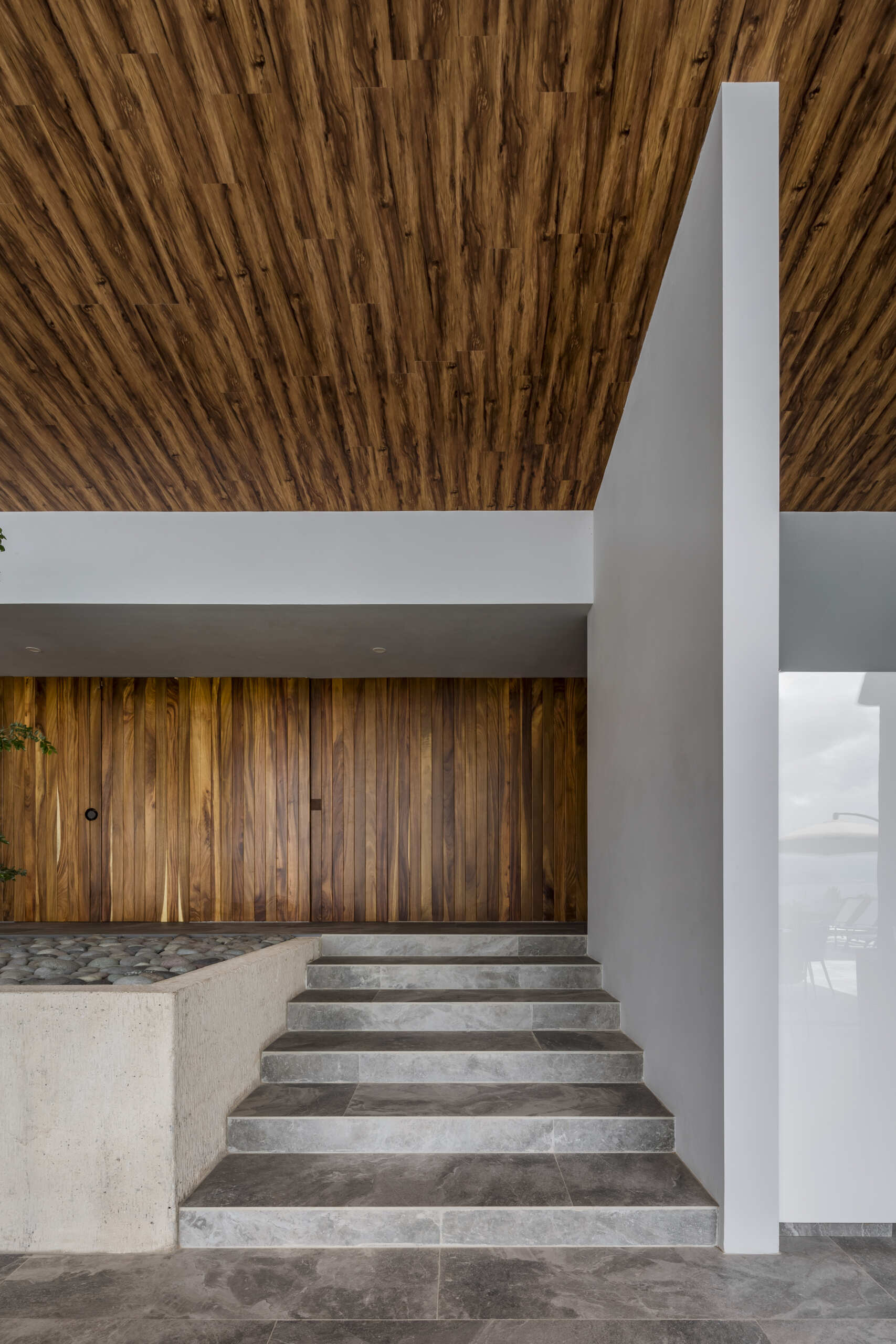 Inside Casa Lago, natural wood and sunlight create a welcoming contrast to the modern lines.