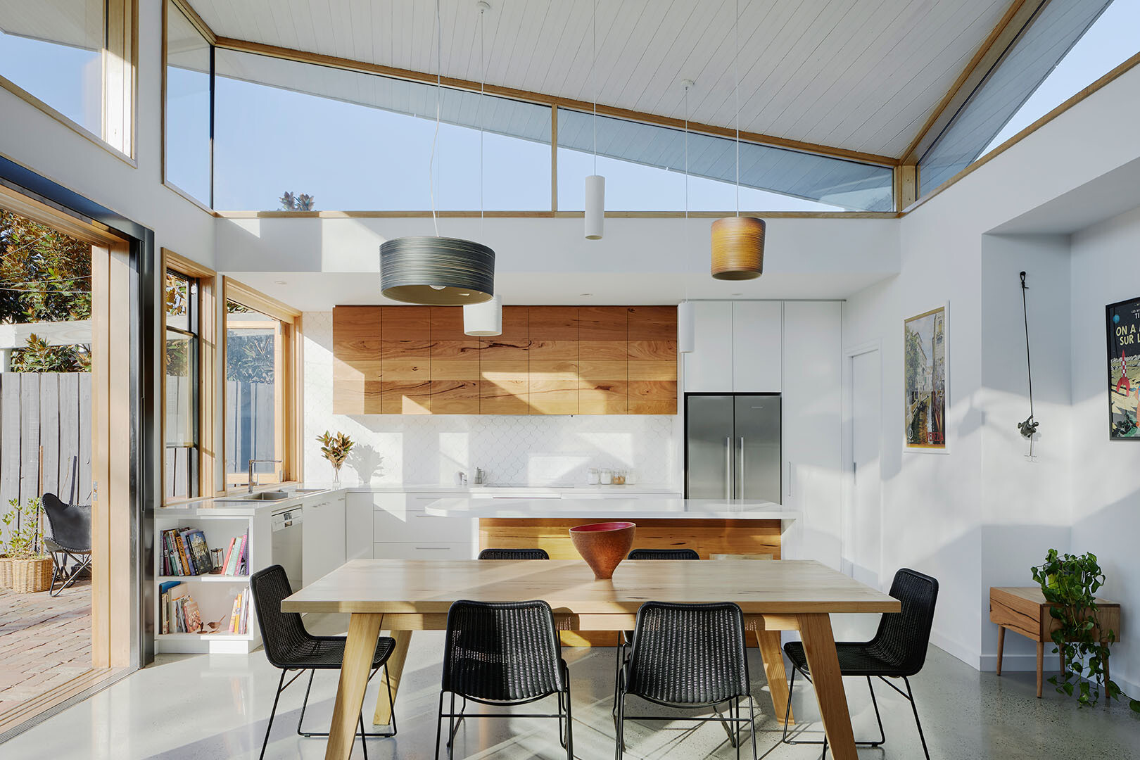 A kitchen window opens to a recycled brick patio, turning into a bar for easy outdoor entertaining, the essence of Australian indoor-outdoor living.