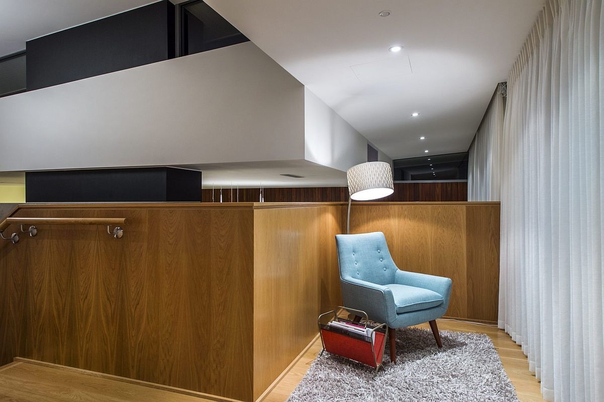 A cozy upstairs sitting area offers the perfect nook for reading or relaxing in soft natural light.