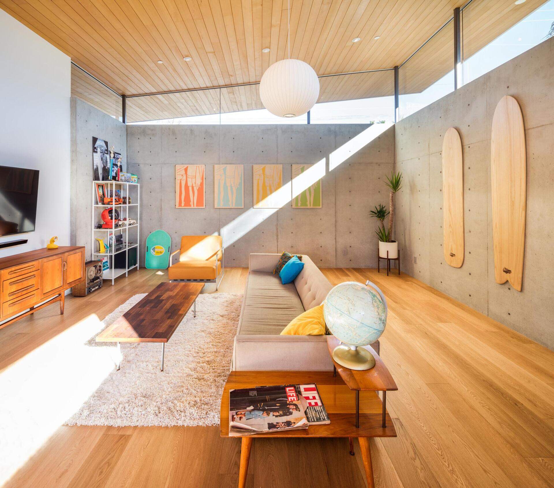 Concrete walls and wood ceilings balance modern warmth with retro charm.