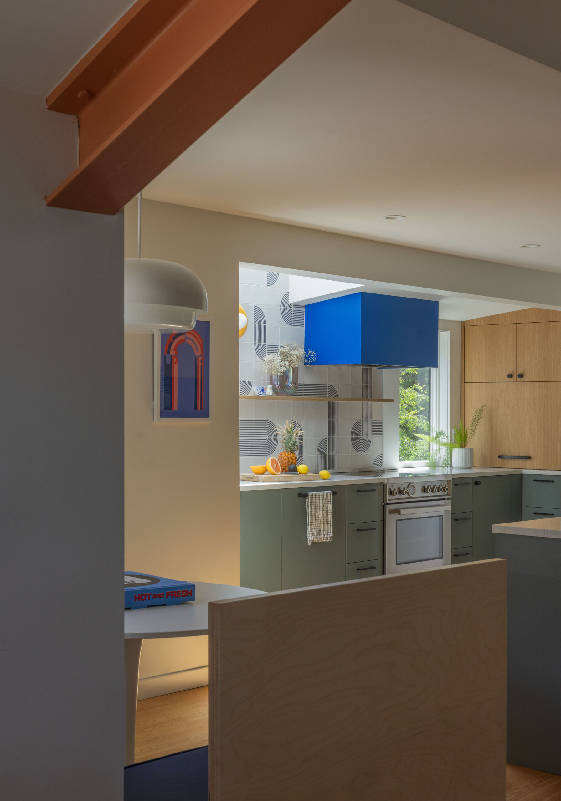 BEFORE - The updated kitchen flows into the dining nook with fresh cabinetry, tile, and appliances.