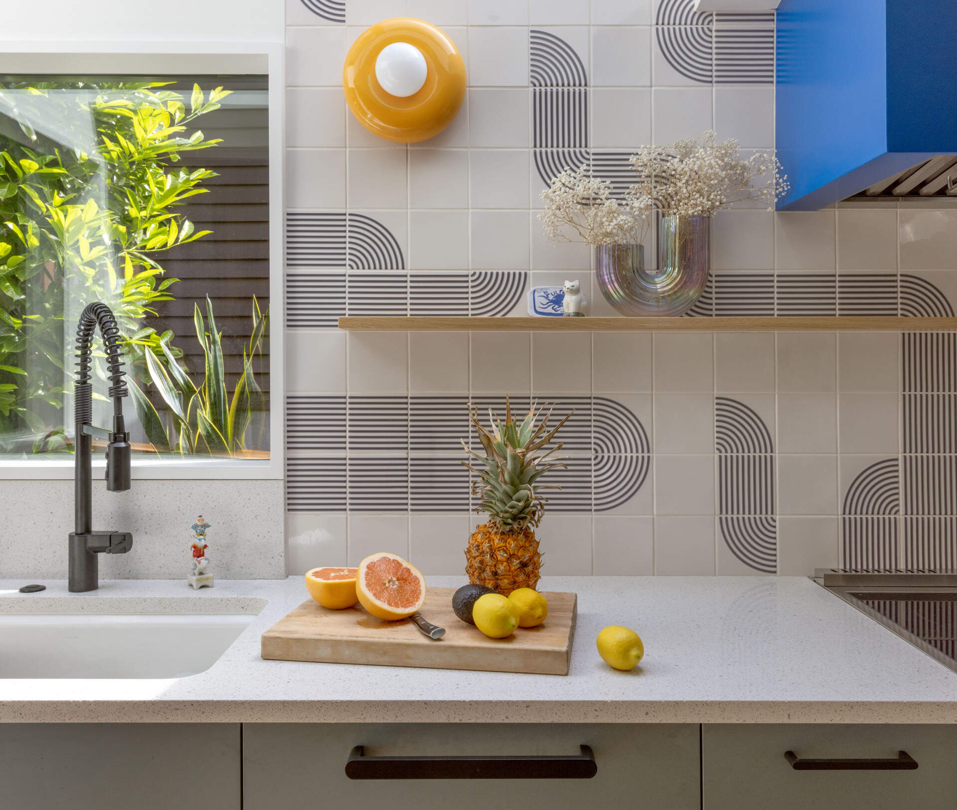 BEFORE - The updated kitchen flows into the dining nook with fresh cabinetry, tile, and appliances.