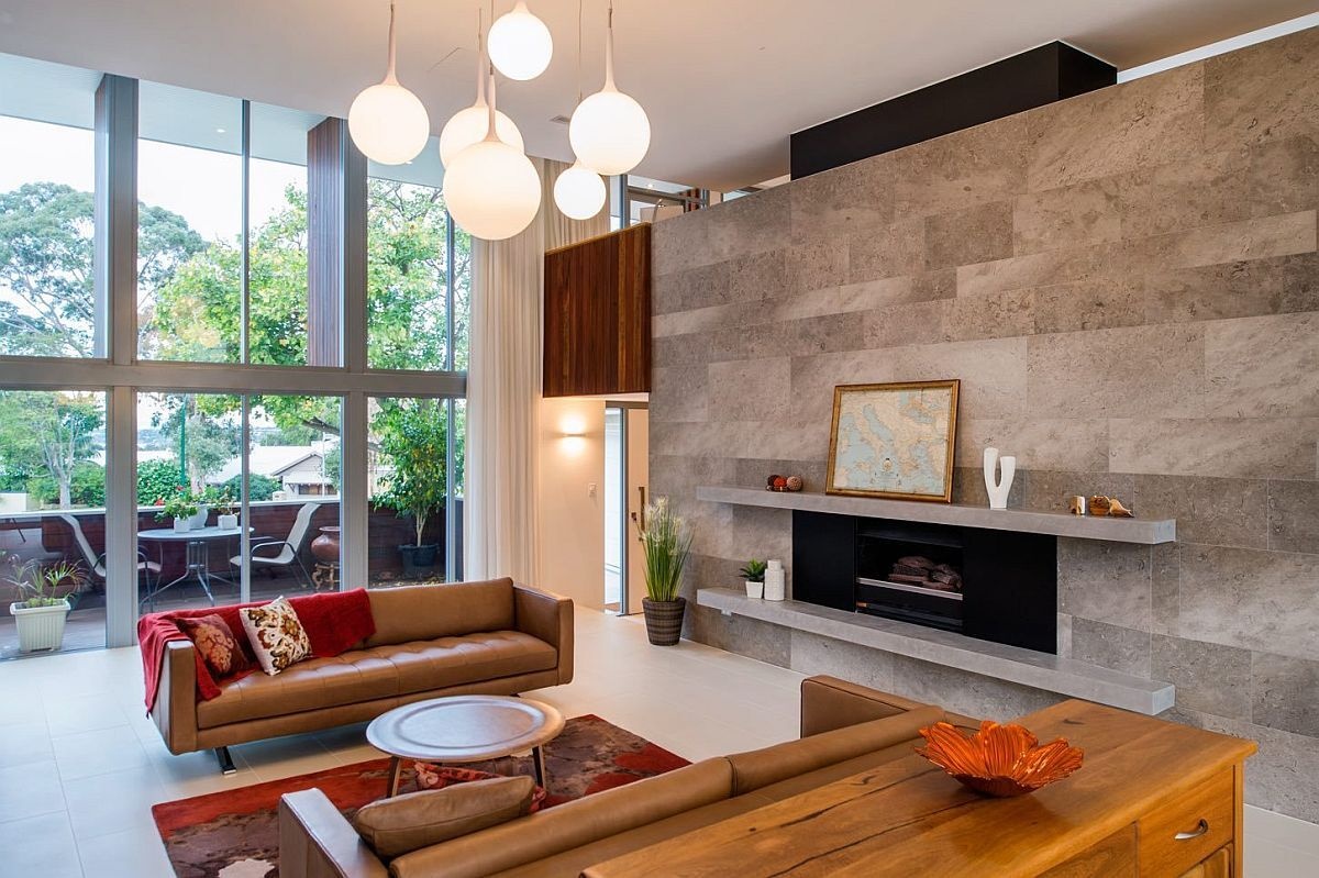 The formal living room pairs a fireplace with custom cabinetry and opens to a small street-facing balcony.
