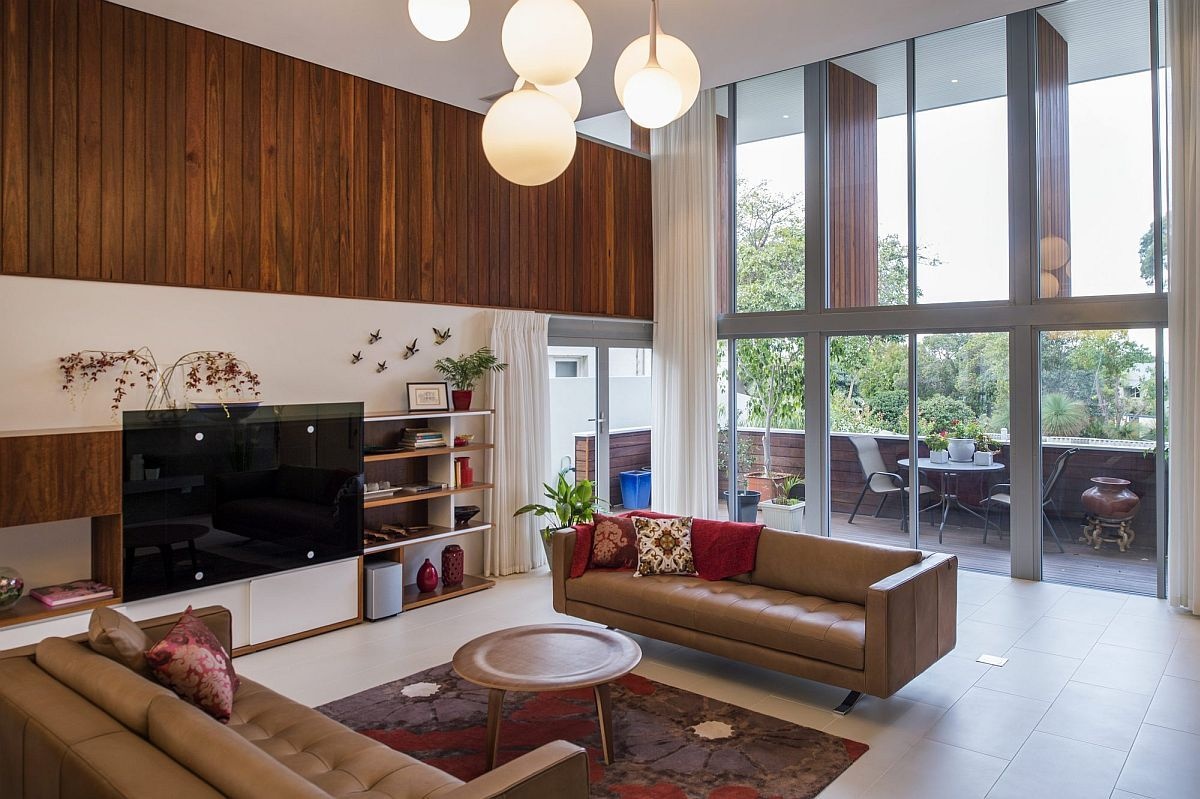 The formal living room pairs a fireplace with custom cabinetry and opens to a small street-facing balcony.