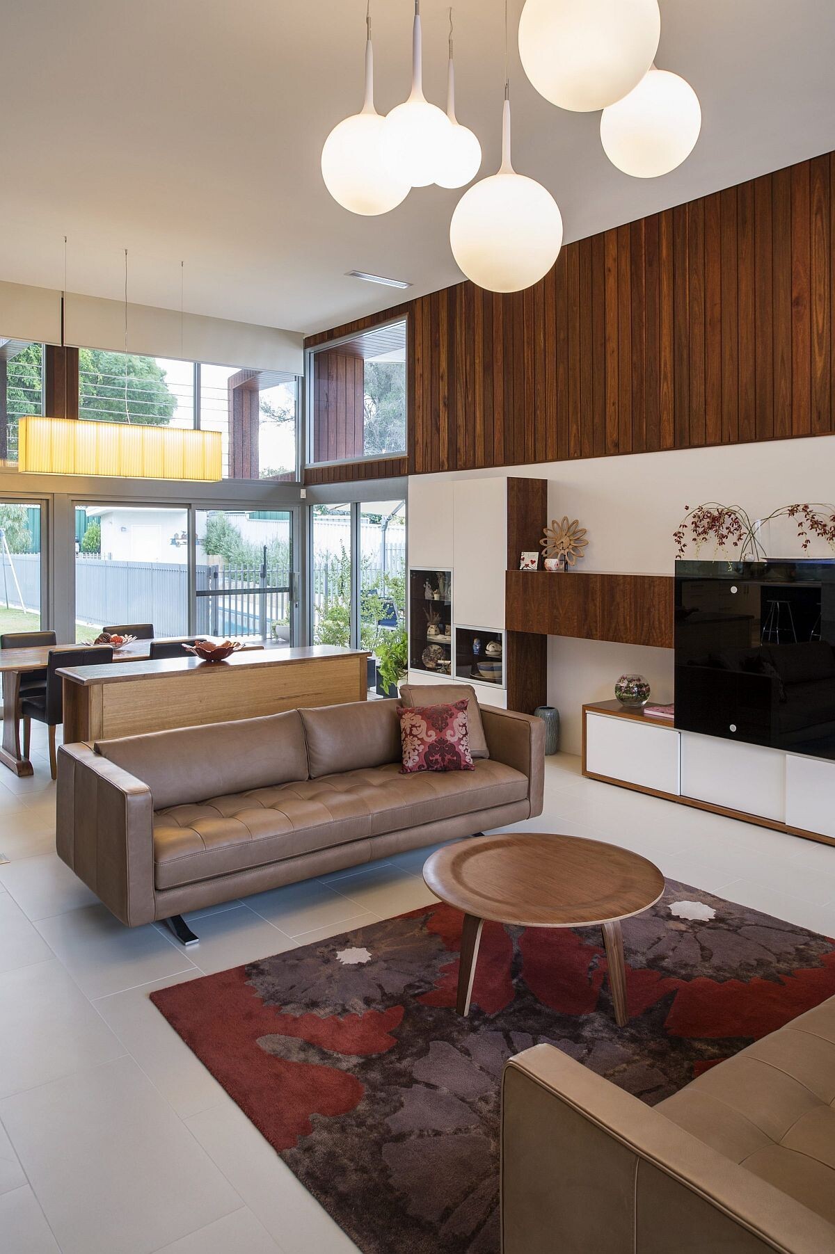 A sideboard subtly separates the dining room, where sliding glass doors lead to the backyard.