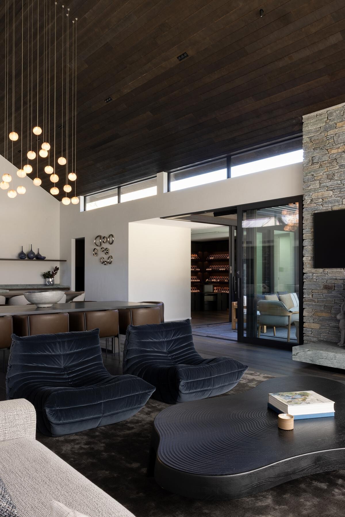 A refined dining area and kitchen by Space Studio, balancing bold architecture with warmth.