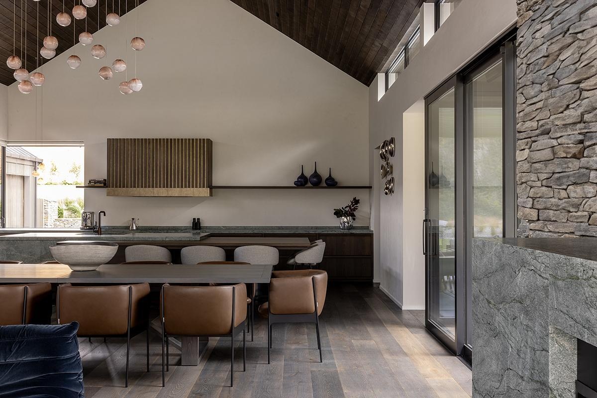 A refined dining area and kitchen by Space Studio, balancing bold architecture with warmth.