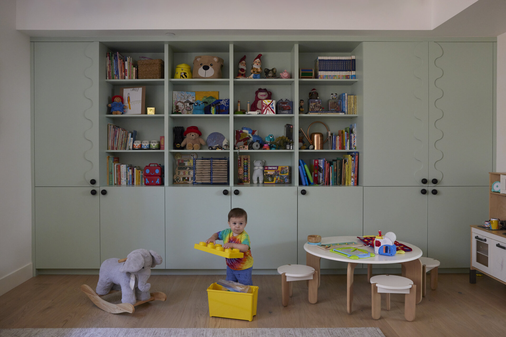 An attached ADU doubles as a playful space for the family, complete with kitchenette and bath. It offers flexibility, shifting between home office and creative zone.