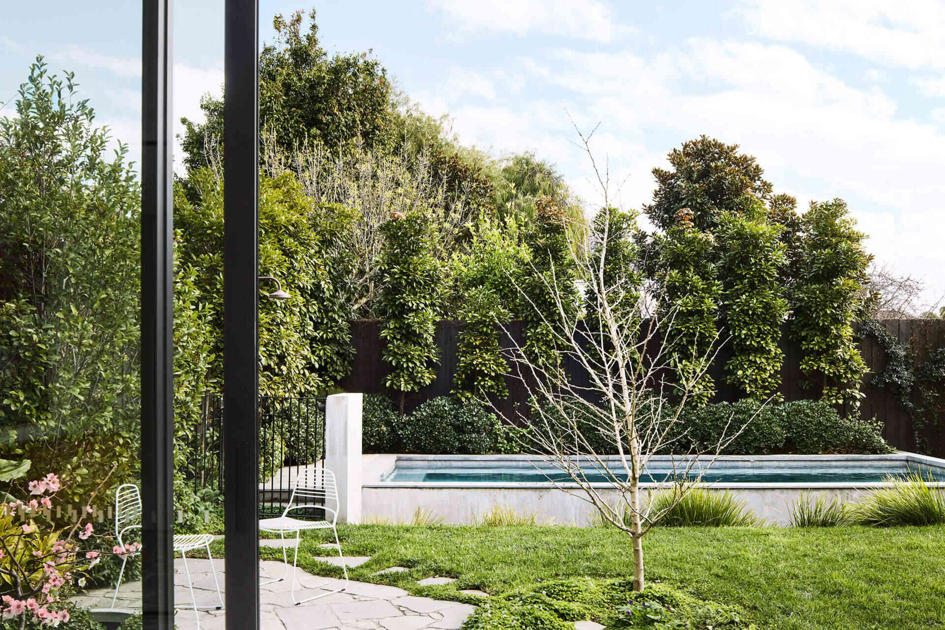 A patio and concealed BBQ blur the line between architecture and garden in this modern Australian home.