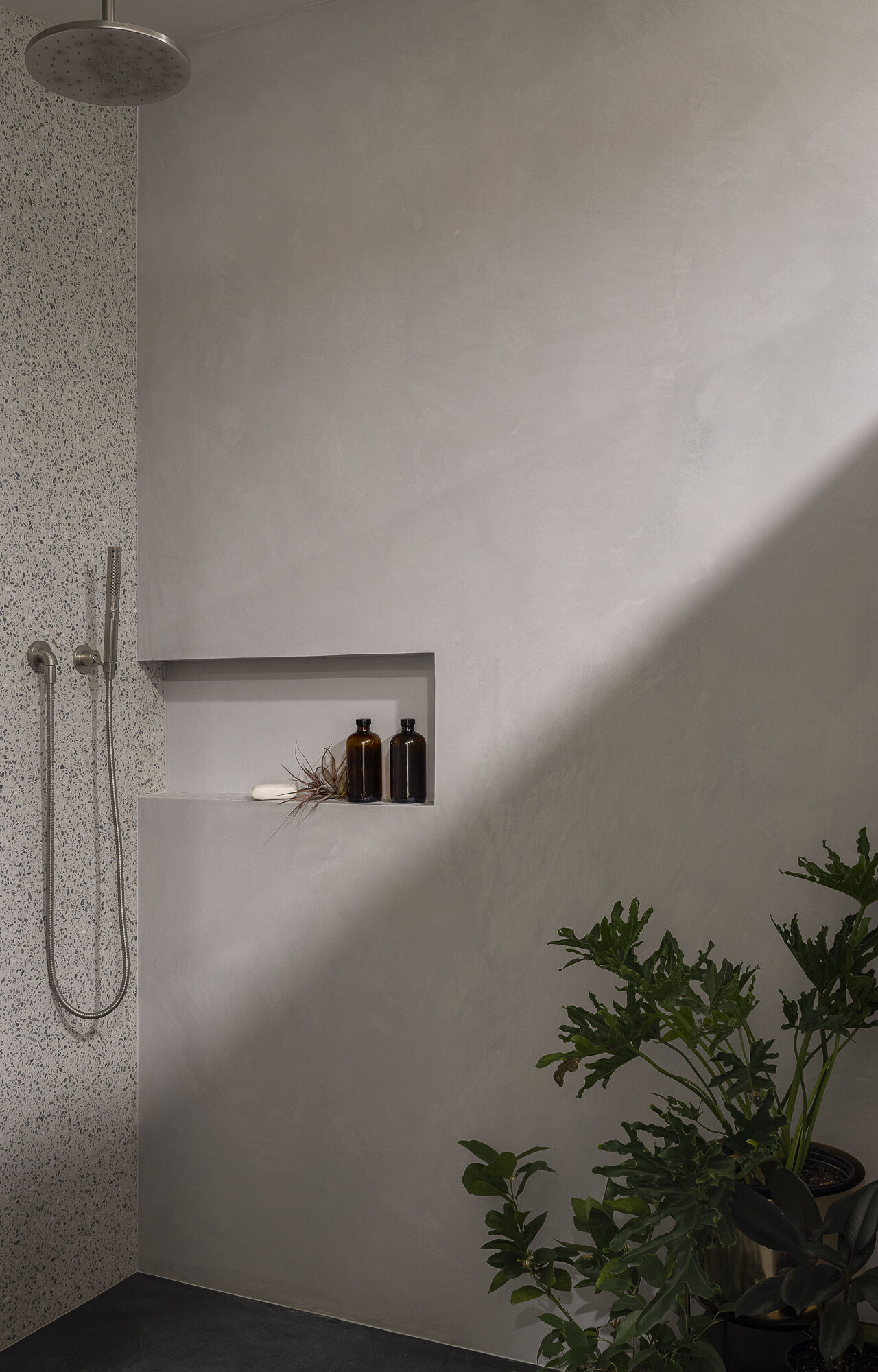 A modern shower with a recessed shelving niche.