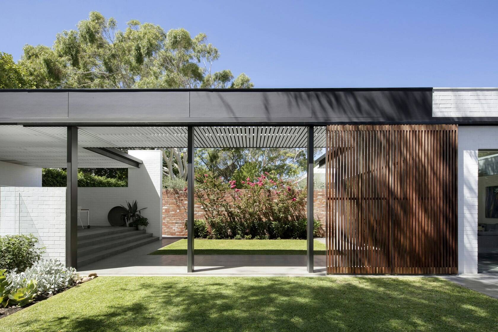 A covered walkway connects each garden zone, blending architecture and landscape effortlessly.