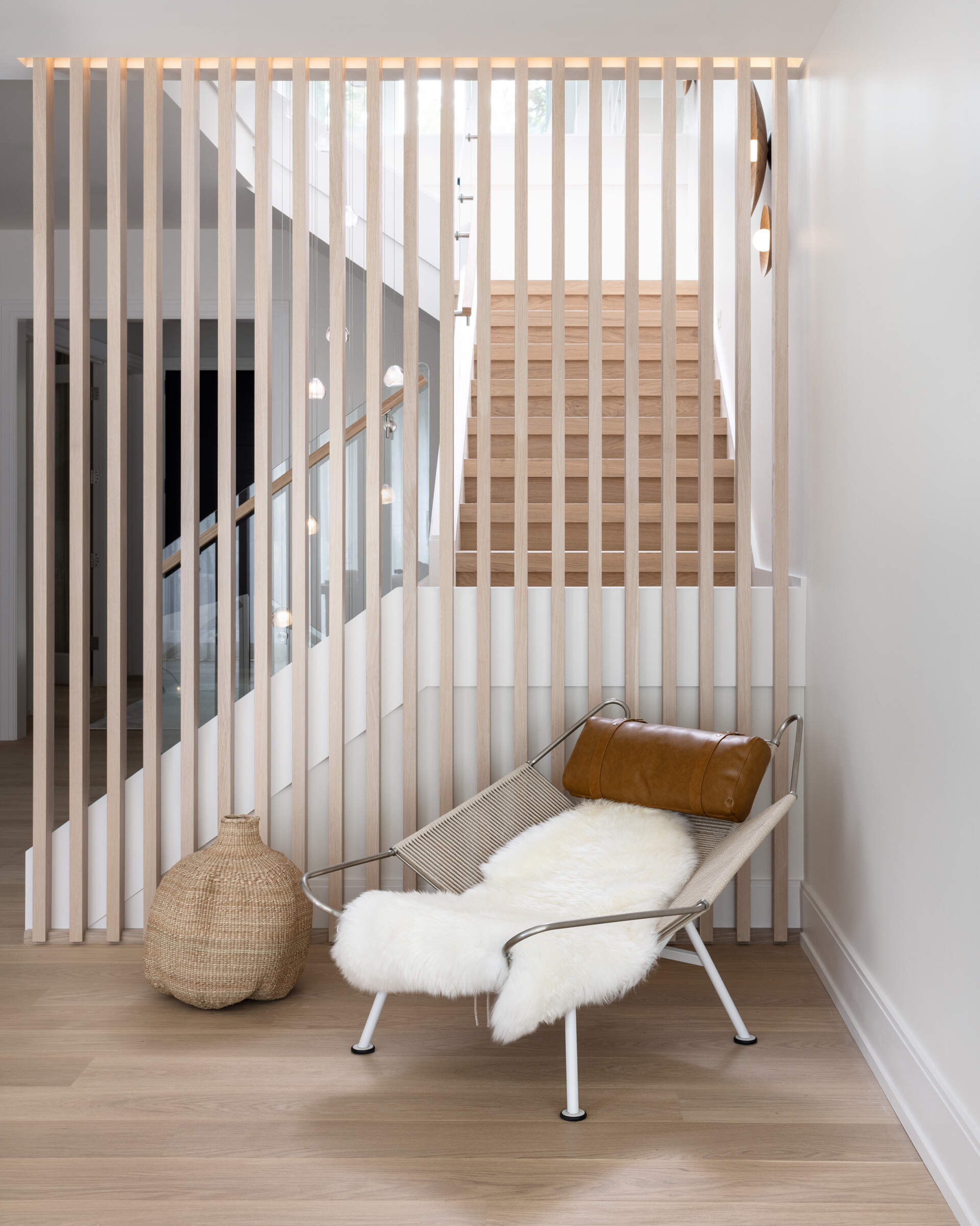 Glass, vertical slats, and floating treads make the staircase a daily sculpture. It filters light across floors and ties the home’s calm geometry together. It is a photograph waiting to happen from every angle.