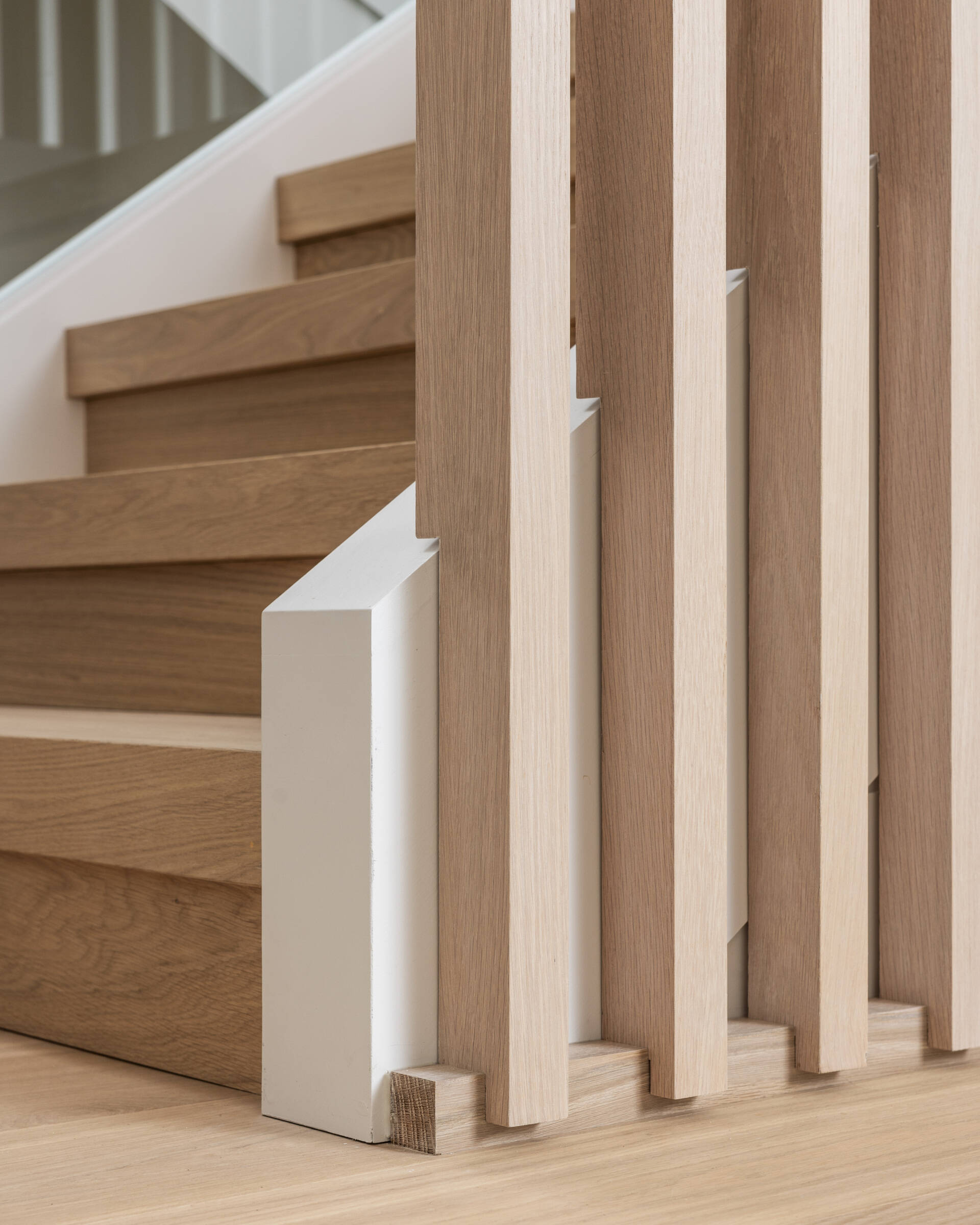 Glass, vertical slats, and floating treads make the staircase a daily sculpture. It filters light across floors and ties the home’s calm geometry together. It is a photograph waiting to happen from every angle.