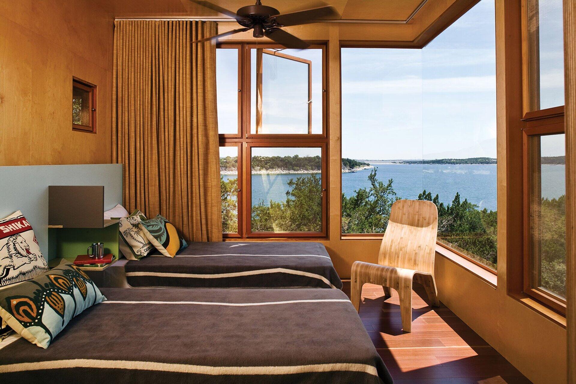 Cozy birch-lined bedrooms with sweeping treetop and lake views make the Tower House a peaceful retreat above the forest floor.