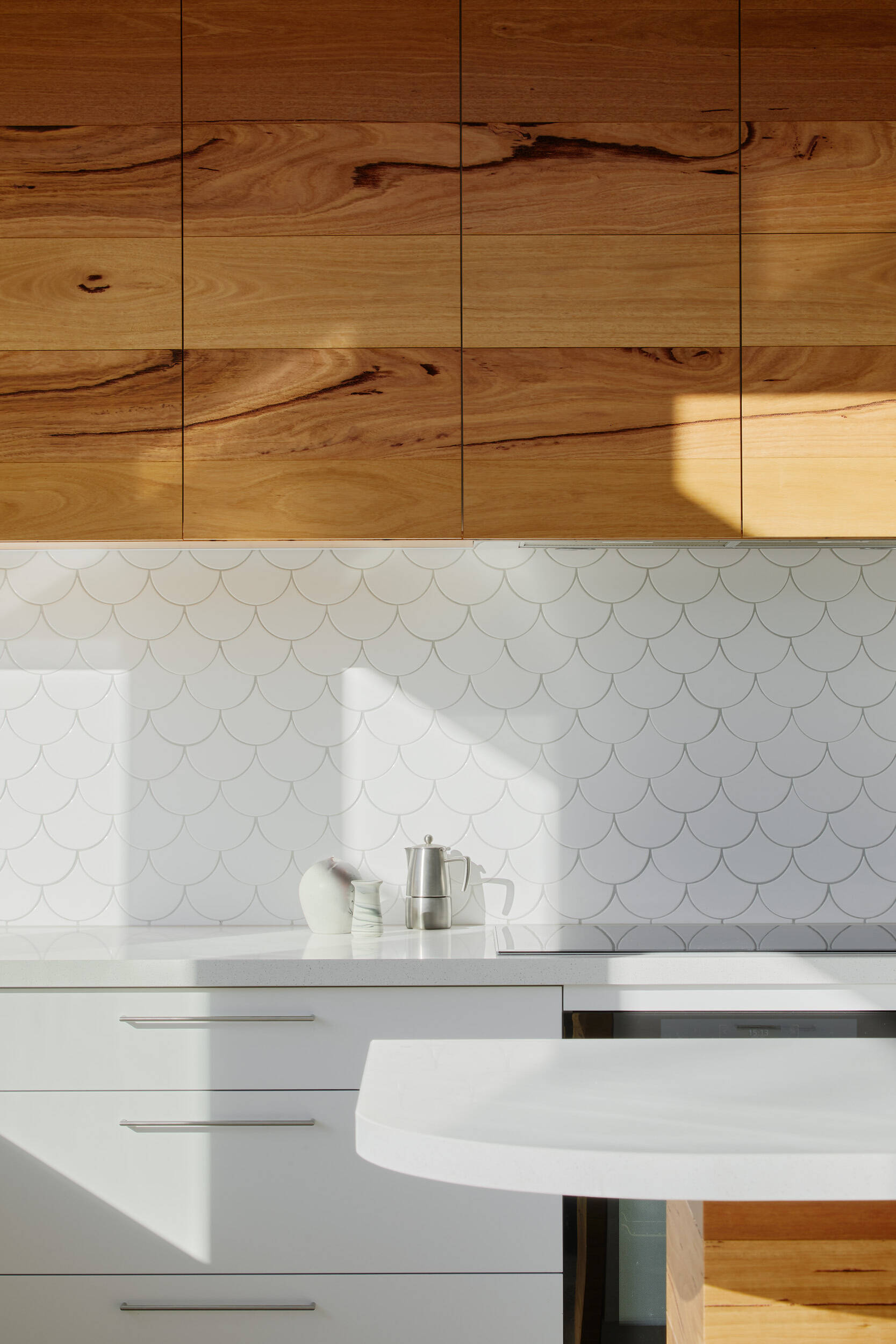 A kitchen window opens to a recycled brick patio, turning into a bar for easy outdoor entertaining, the essence of Australian indoor-outdoor living.