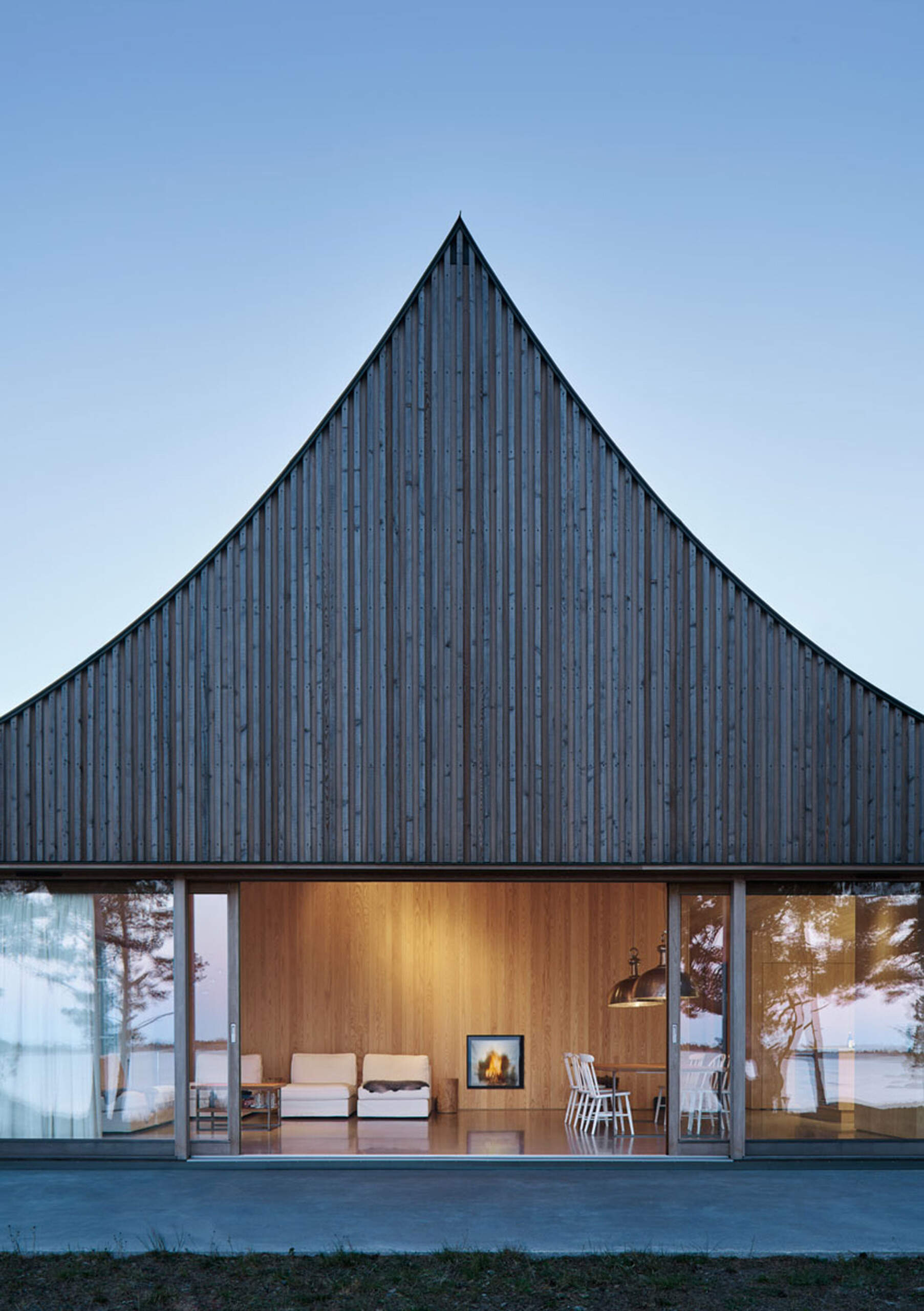Set against the Baltic Sea, the cedar facade and curved roof of this island retreat create a timeless connection to the rugged Scandinavian landscape.