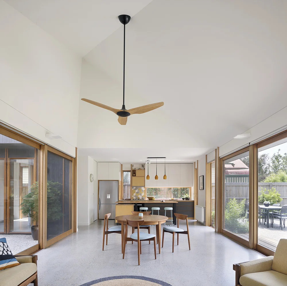Open-plan living flows seamlessly to the outdoors, with sliding doors and timber details tying the whole home together.