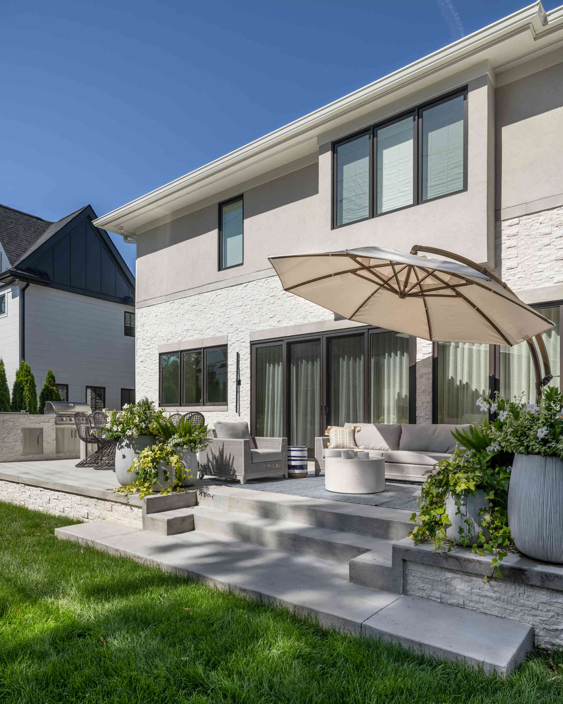 Slide the glass wide and the living space keeps going. The lanai picks up the home’s palette, so there is no harsh break between inside and out. You get firepit nights, breezy lunches, and that rare sense that the house is relaxing with you.