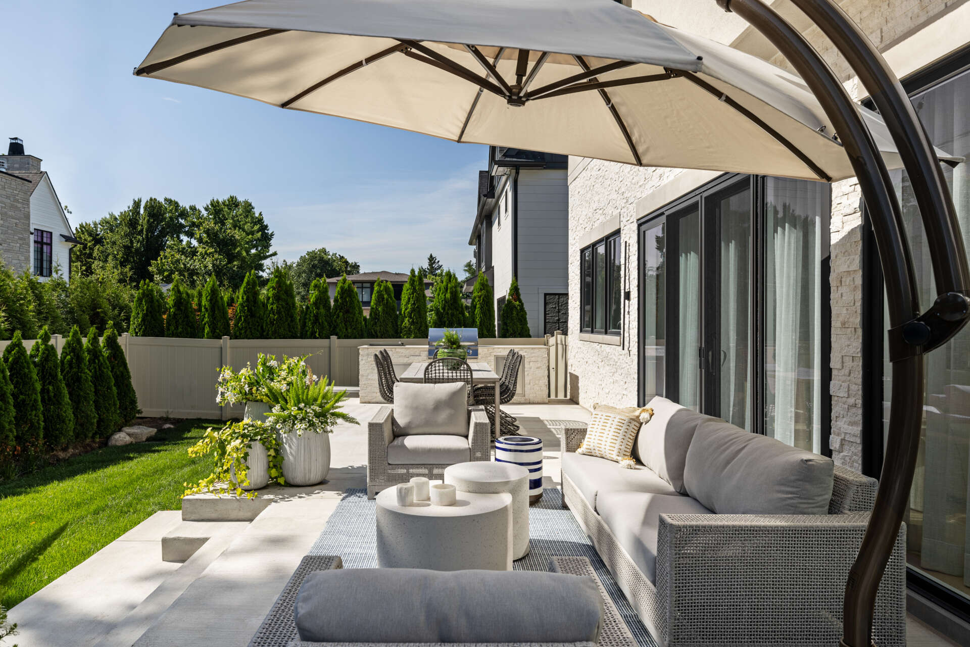 Slide the glass wide and the living space keeps going. The lanai picks up the home’s palette, so there is no harsh break between inside and out. You get firepit nights, breezy lunches, and that rare sense that the house is relaxing with you.