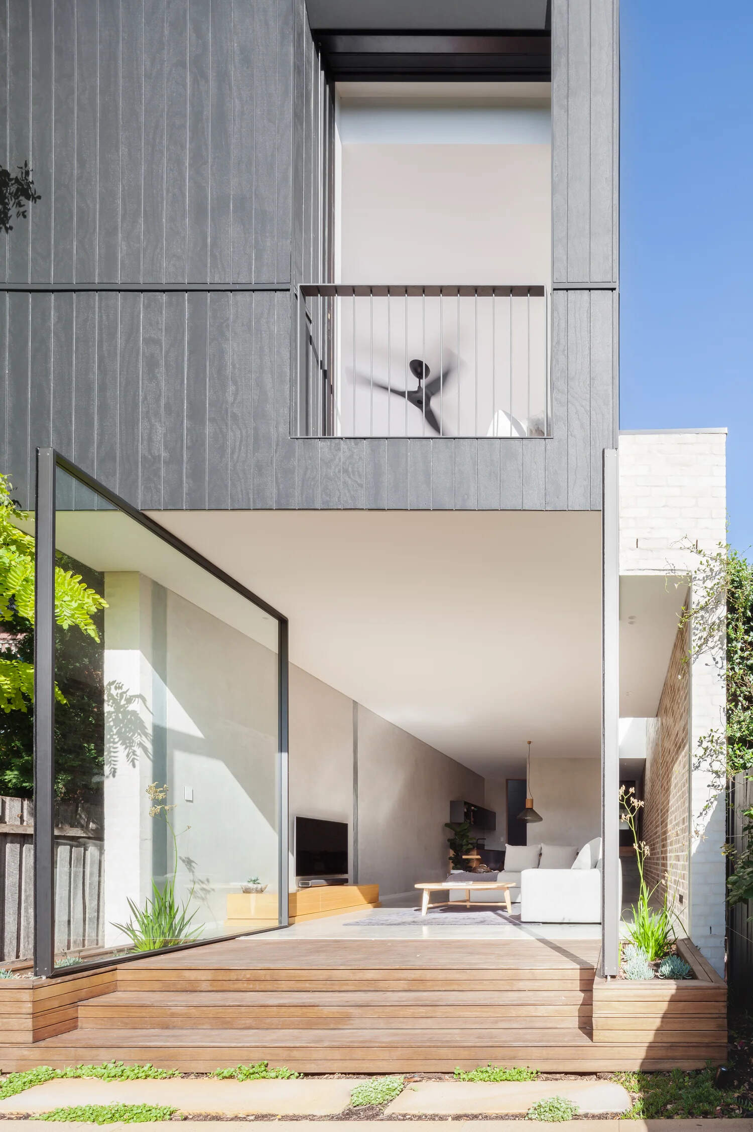 Minimalist glass pivot doors make bold architectural statements in modern interiors.