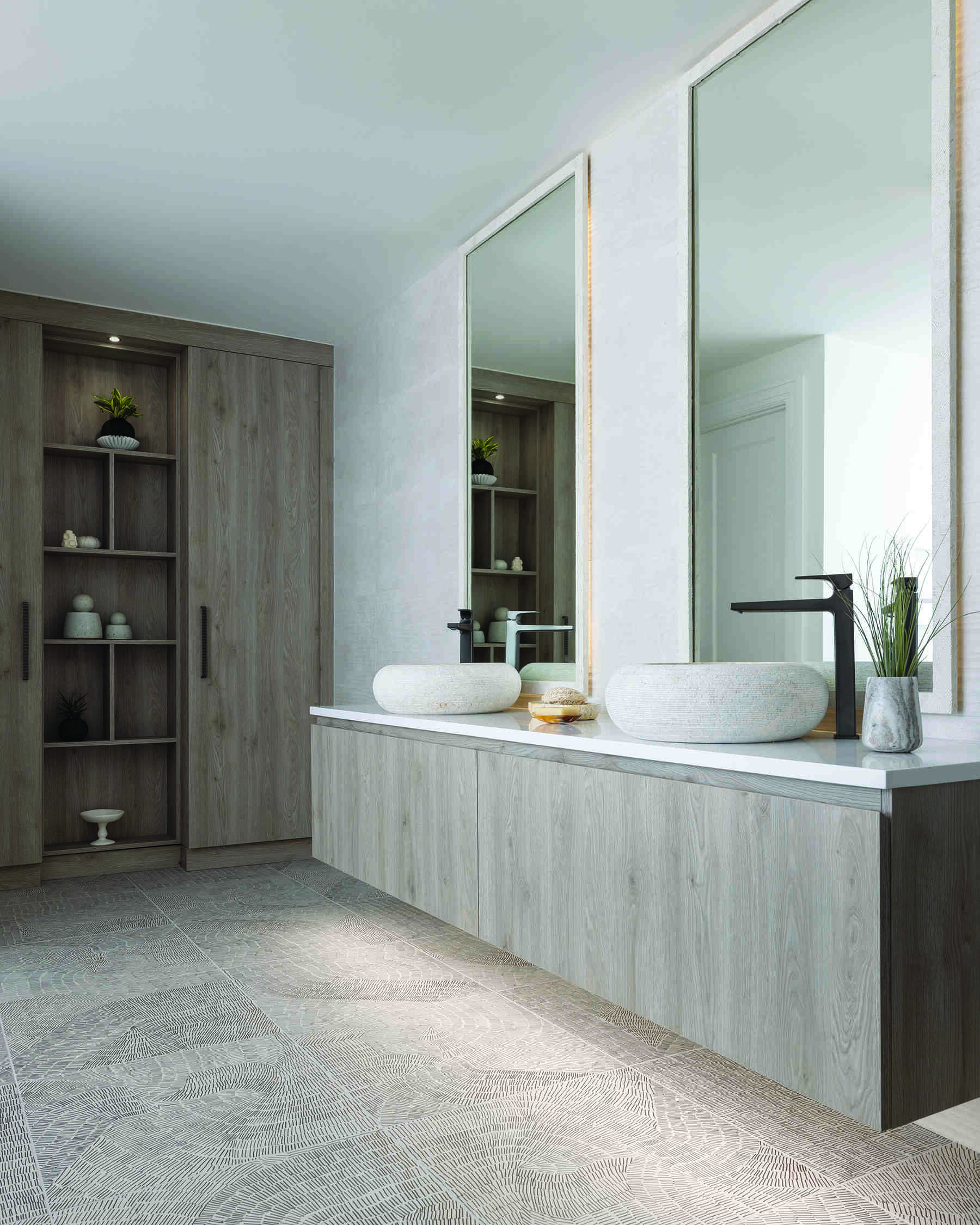 The primary bathroom suite is the headline act. An open layout centers on a double-sided fireplace that stretches from the shower through to the adjoining bedroom. Slide the sleek door closed for privacy or leave it open and let the flames link the two spaces. Morning routine or evening soak, the mood is pure cocoon.
Fixtures earn their place. A Celestica soaking tub sits like a quiet sculpture. Hansgrohe faucets and accessories add precision without fuss. Cabinetry by Scavolini, crafted from Eco Wood, brings a sustainable edge. The materials feel modern, but they are also mindful, which suits the home’s calm brief.