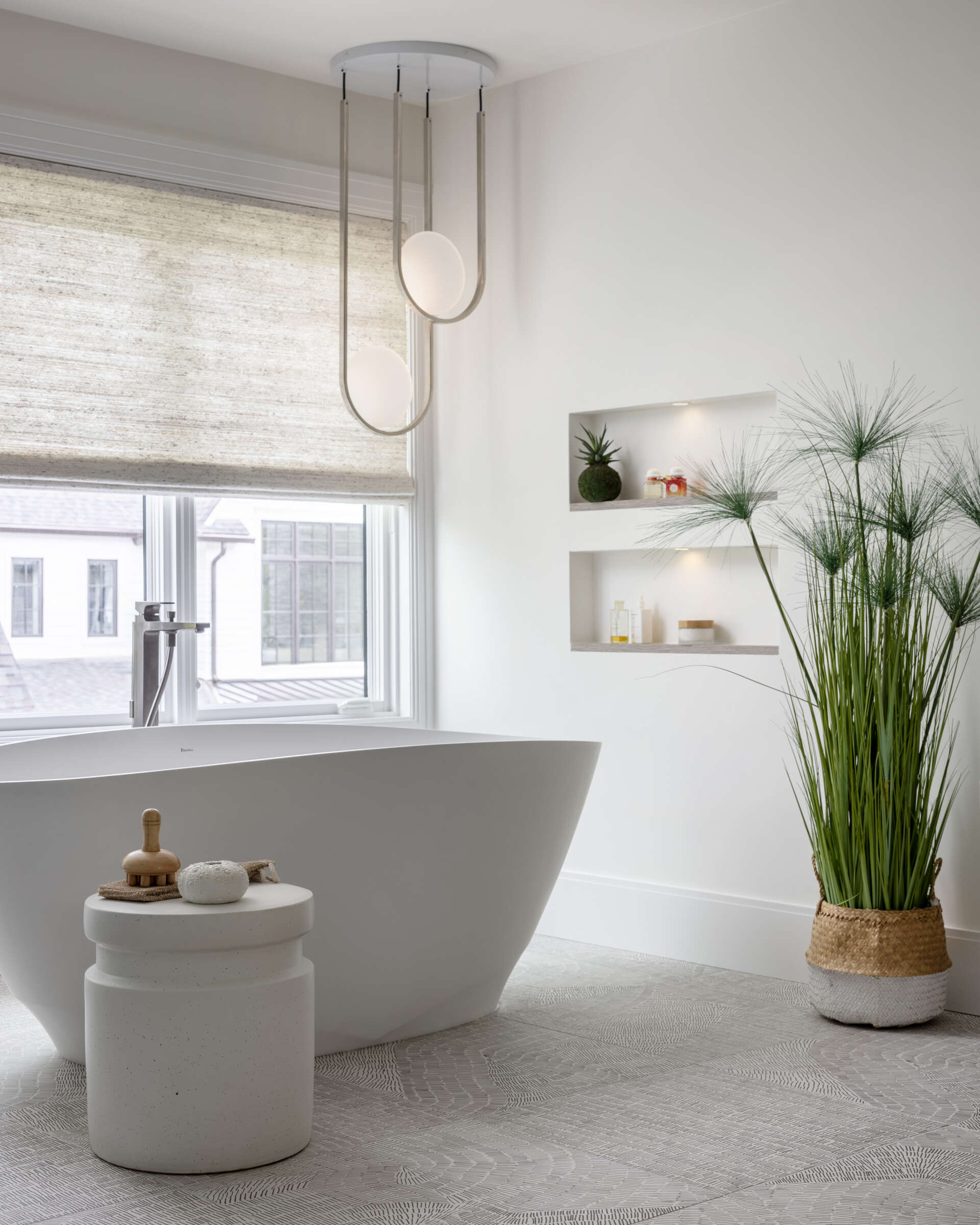 The primary bathroom suite is the headline act. An open layout centers on a double-sided fireplace that stretches from the shower through to the adjoining bedroom. Slide the sleek door closed for privacy or leave it open and let the flames link the two spaces. Morning routine or evening soak, the mood is pure cocoon.
Fixtures earn their place. A Celestica soaking tub sits like a quiet sculpture. Hansgrohe faucets and accessories add precision without fuss. Cabinetry by Scavolini, crafted from Eco Wood, brings a sustainable edge. The materials feel modern, but they are also mindful, which suits the home’s calm brief.