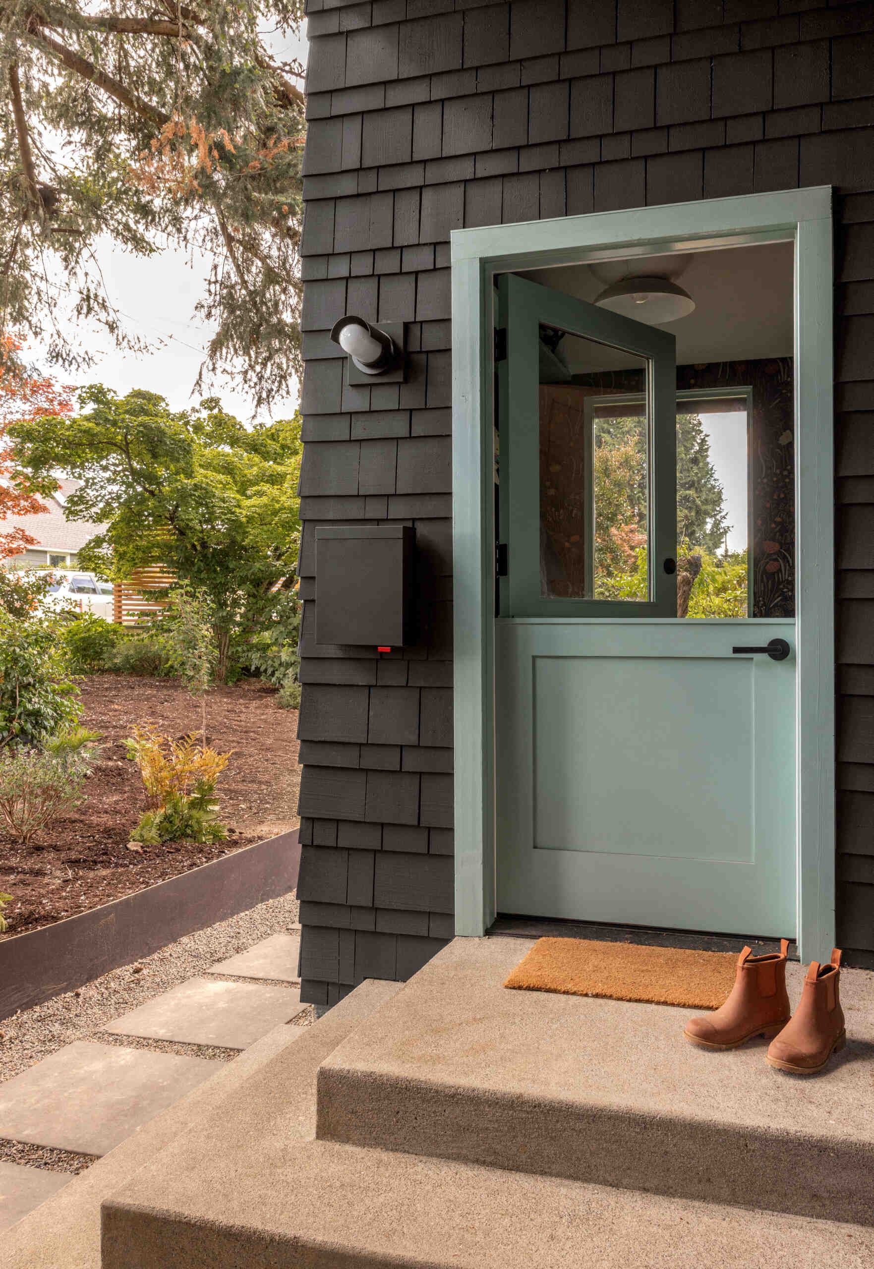 See how a bright teal addition transformed the street view of this 1919 Seattle home while preserving its historic layers.